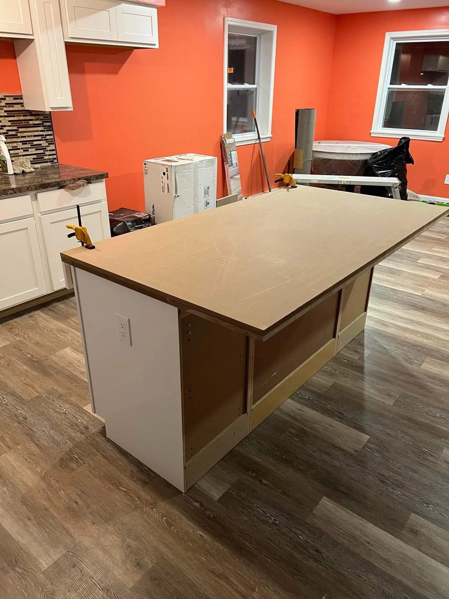 Custom built kitchen island with double overhang and integrated electrical outlets by DLR Construction