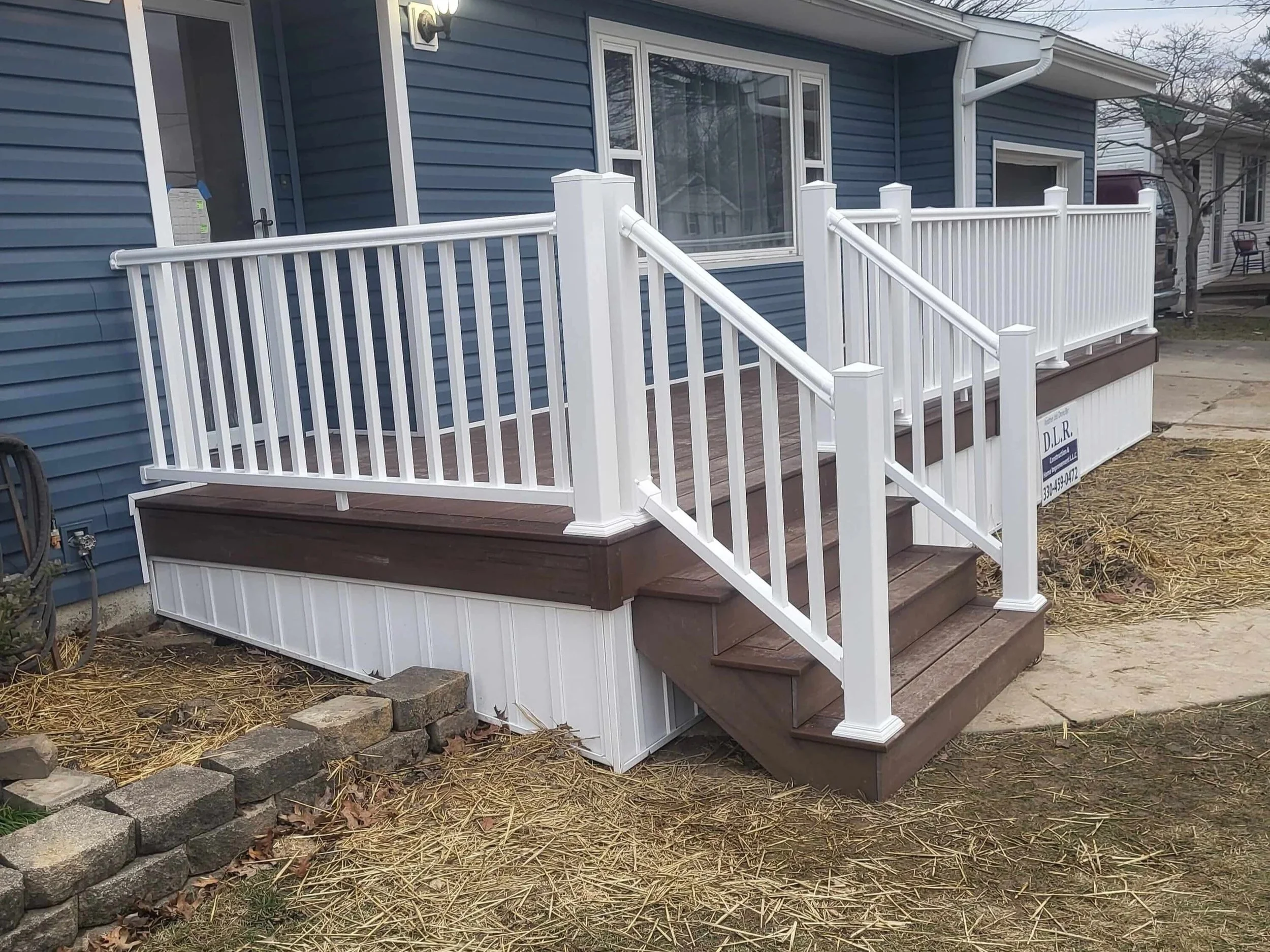 DLR Construction custom front entry composite deck build with white trim skirting and framing in Akron Ohio