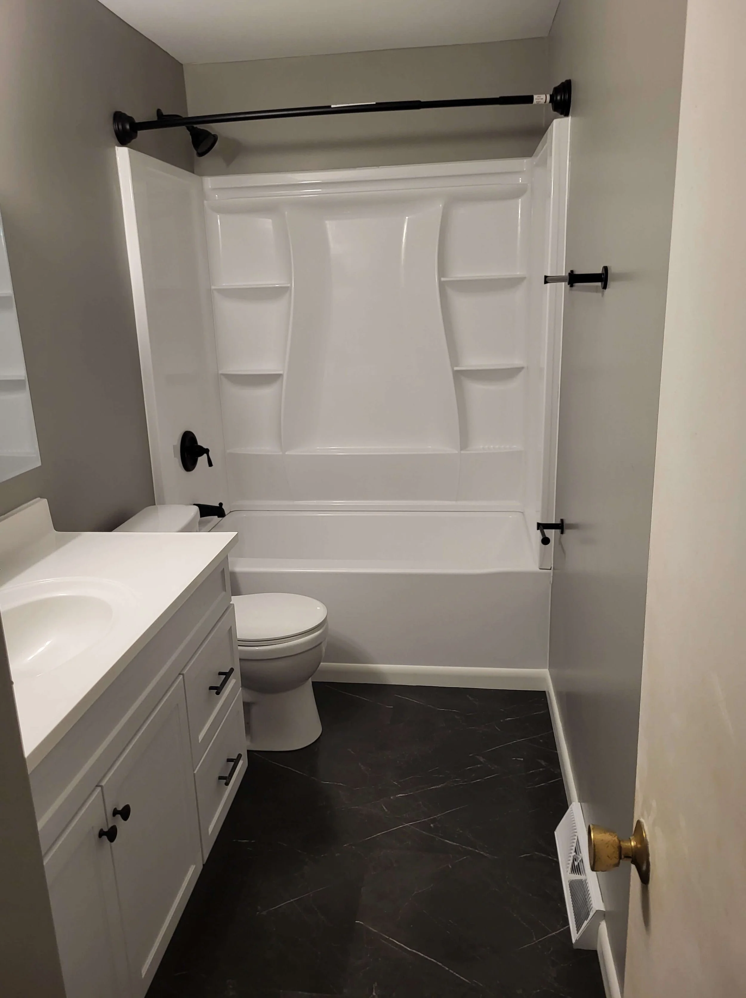 DLR Construction home remodeling services in Northeast Ohio showing a complete modern bathroom renovation with a crisp white tub surround