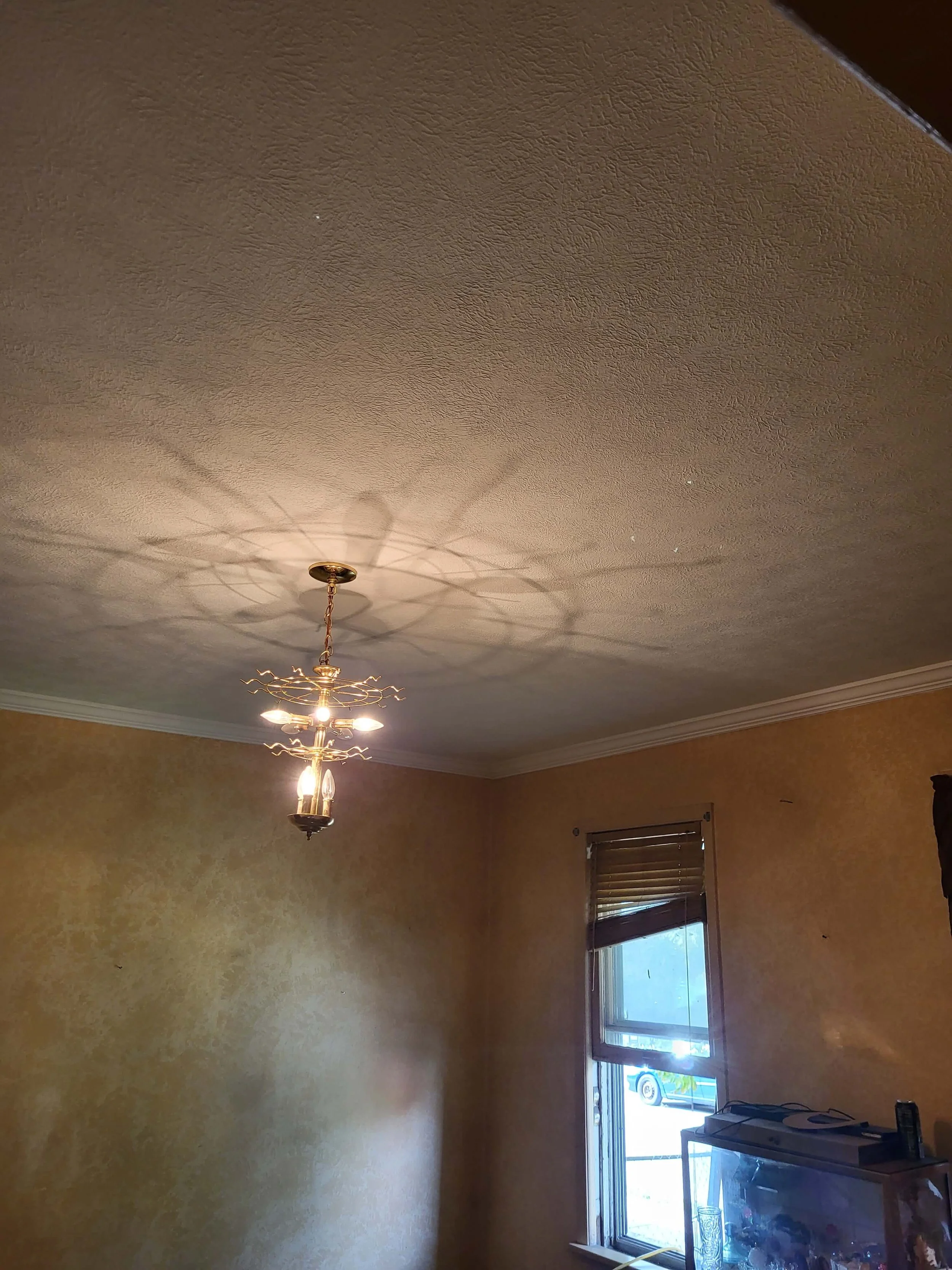 DLR Construction Remodeled residential room in Medina, Ohio showing fully restored plaster ceilings, updated light fixtures, and professional drywall remediation following water damage.