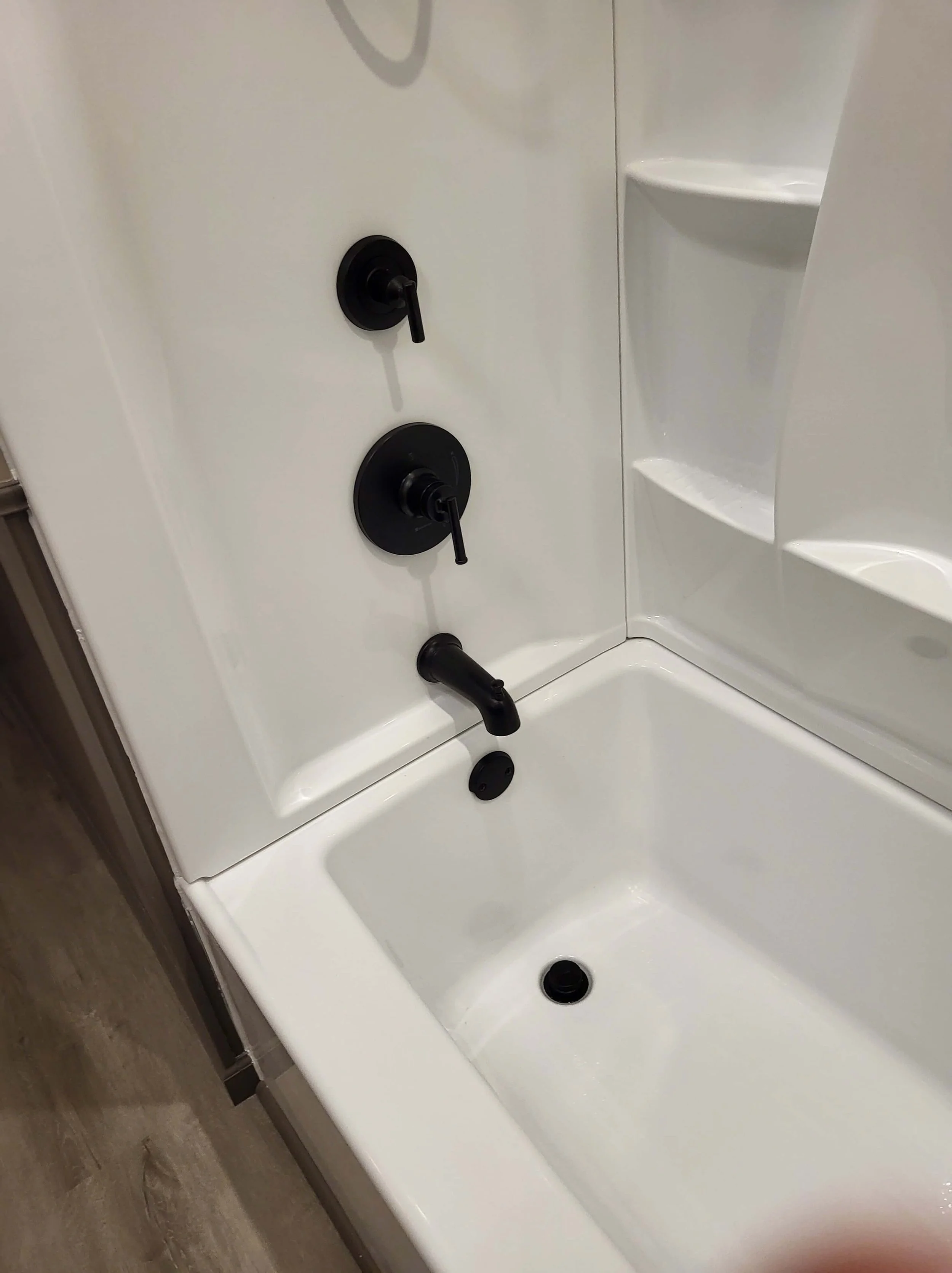 Black shower fixtures in finished modern bathroom renovation Northeast Ohio