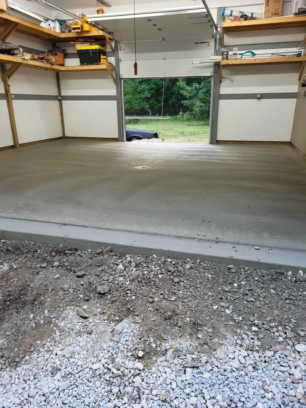 Clean interior view of the robust 5 inch thick reinforced concrete floor slab designed to handle multi ton automotive point loads.