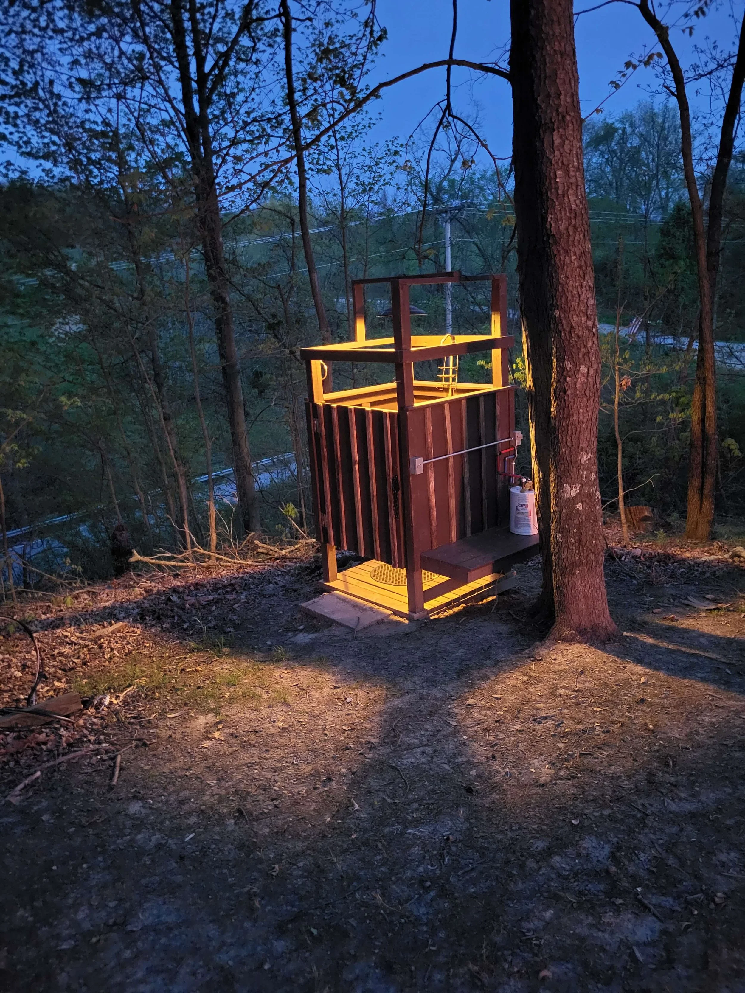 DLR Custom built timber outdoor shower enclosure with integrated evening lighting on a residential property in Northeast Ohio.