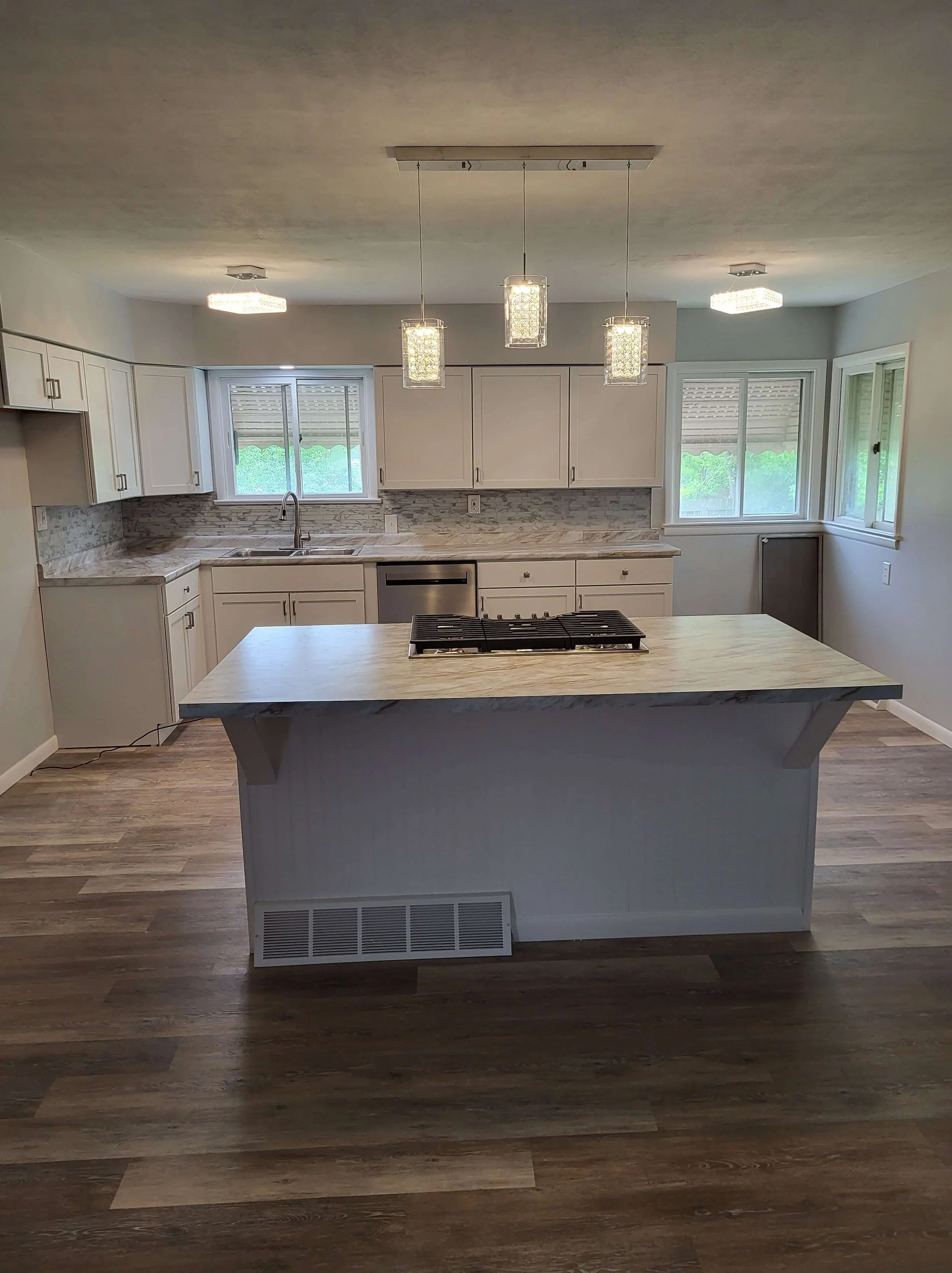 Open-Concept Kitchen Remodel by DLR. Custom built Island with Laminate Countertop. Backsplash, Flooring, Lighting, And more!
