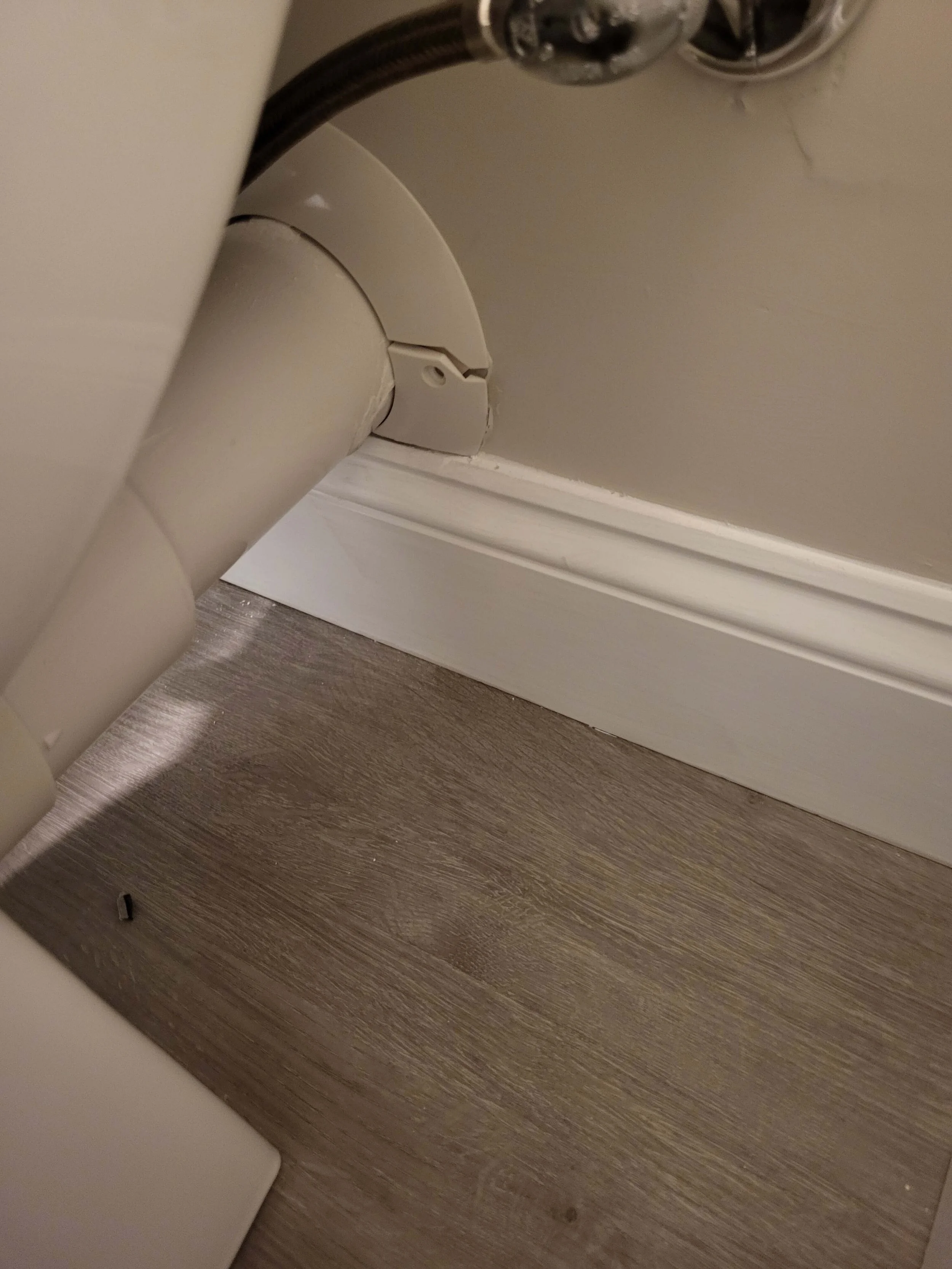 Modern gray bathroom vanity and luxury vinyl plank flooring installed in a finished basement by DLR Construction.