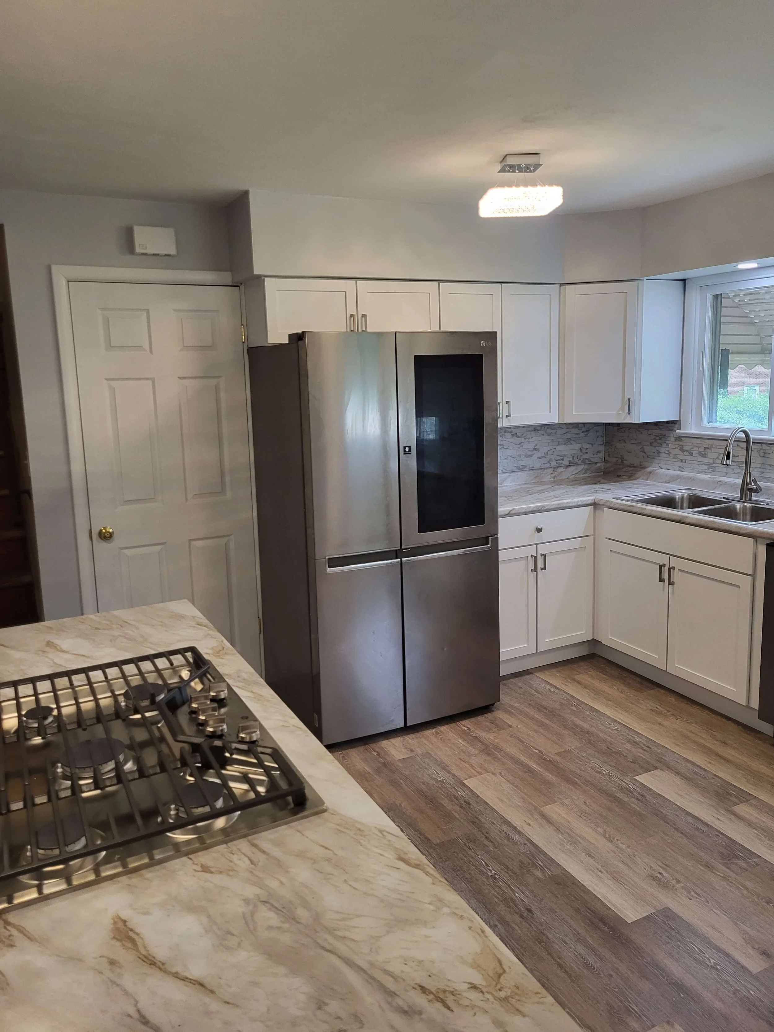 New refrigerator and dishwasher installation completed during kitchen remodel by DLR Construction.