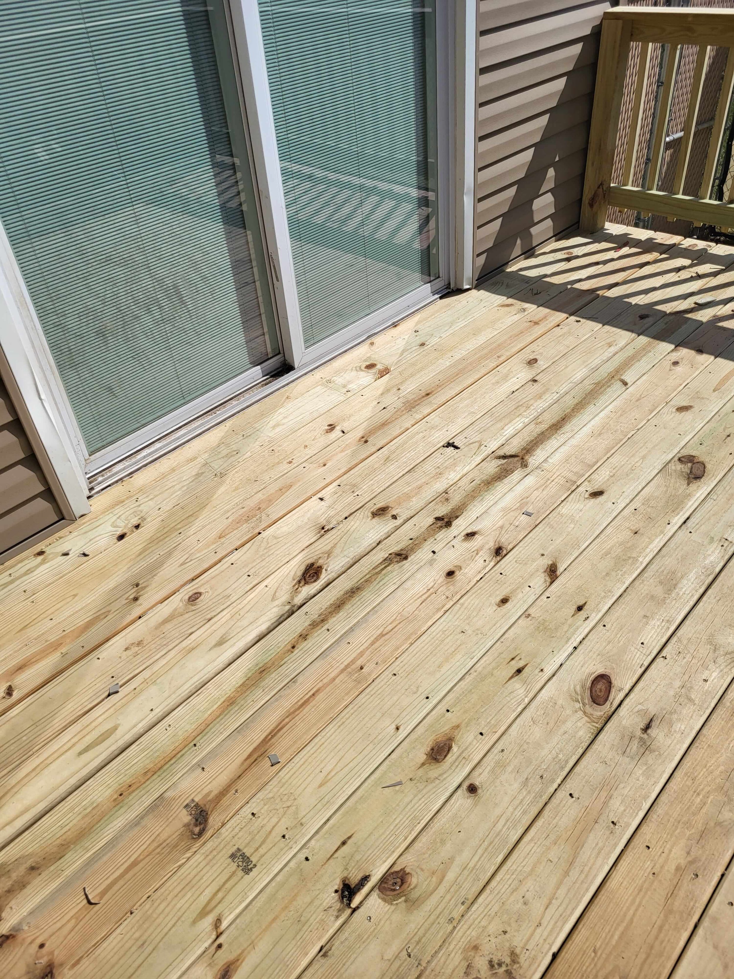 Close-up showing the sliding door and new deck seamlessly integrated into the house wall in Canton, Ohio — zero gaps, clean joint, and fully functional entry point
