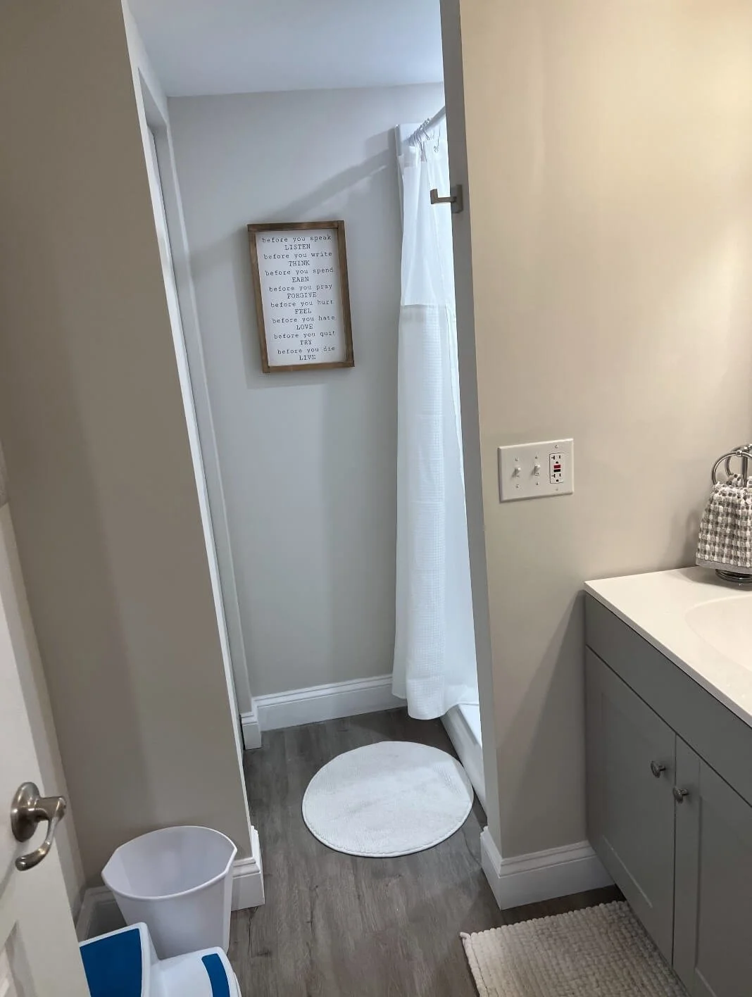 Modern finished basement bathroom with clean layout and lighting