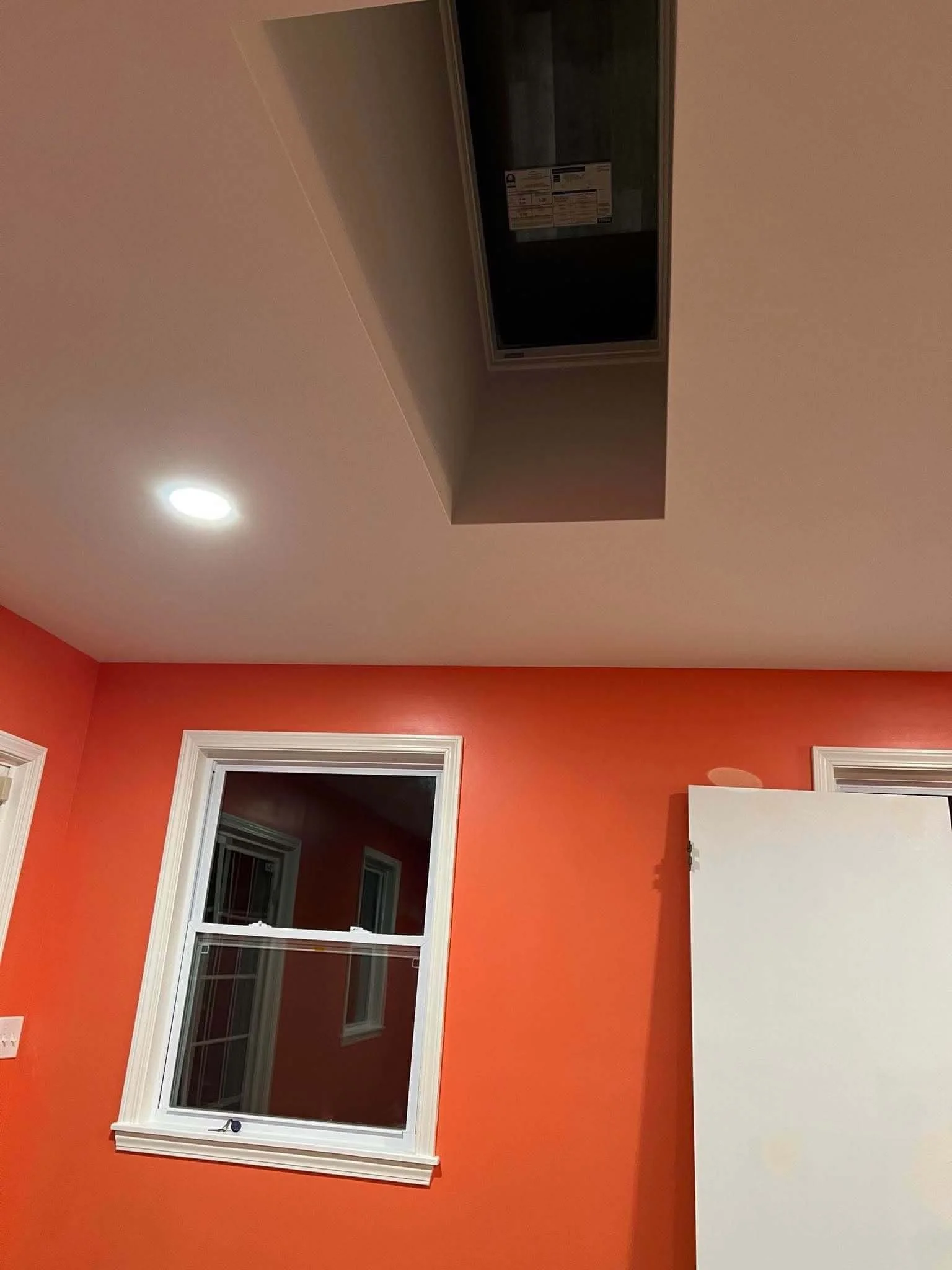 Close up view of a home addition project during drywall installation and ceiling skylights and recessed lighting by DLR.