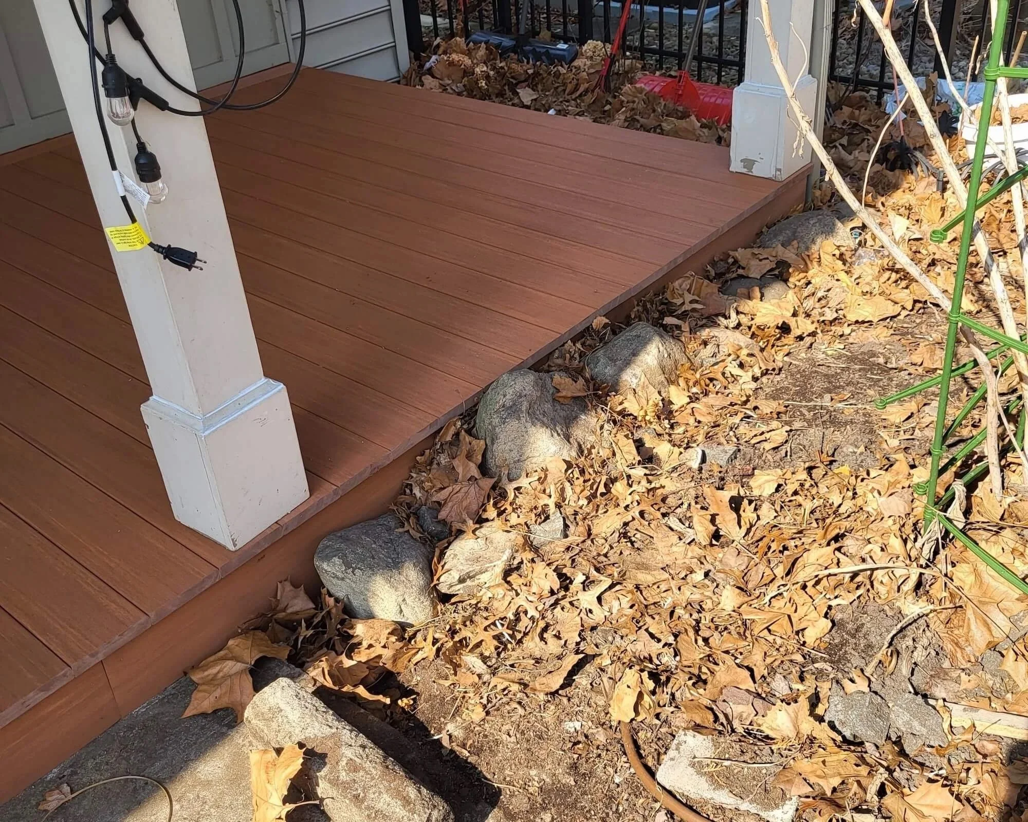 Straight-on view of a covered front porch and full-width entrance deck on a Northeast Ohio home.