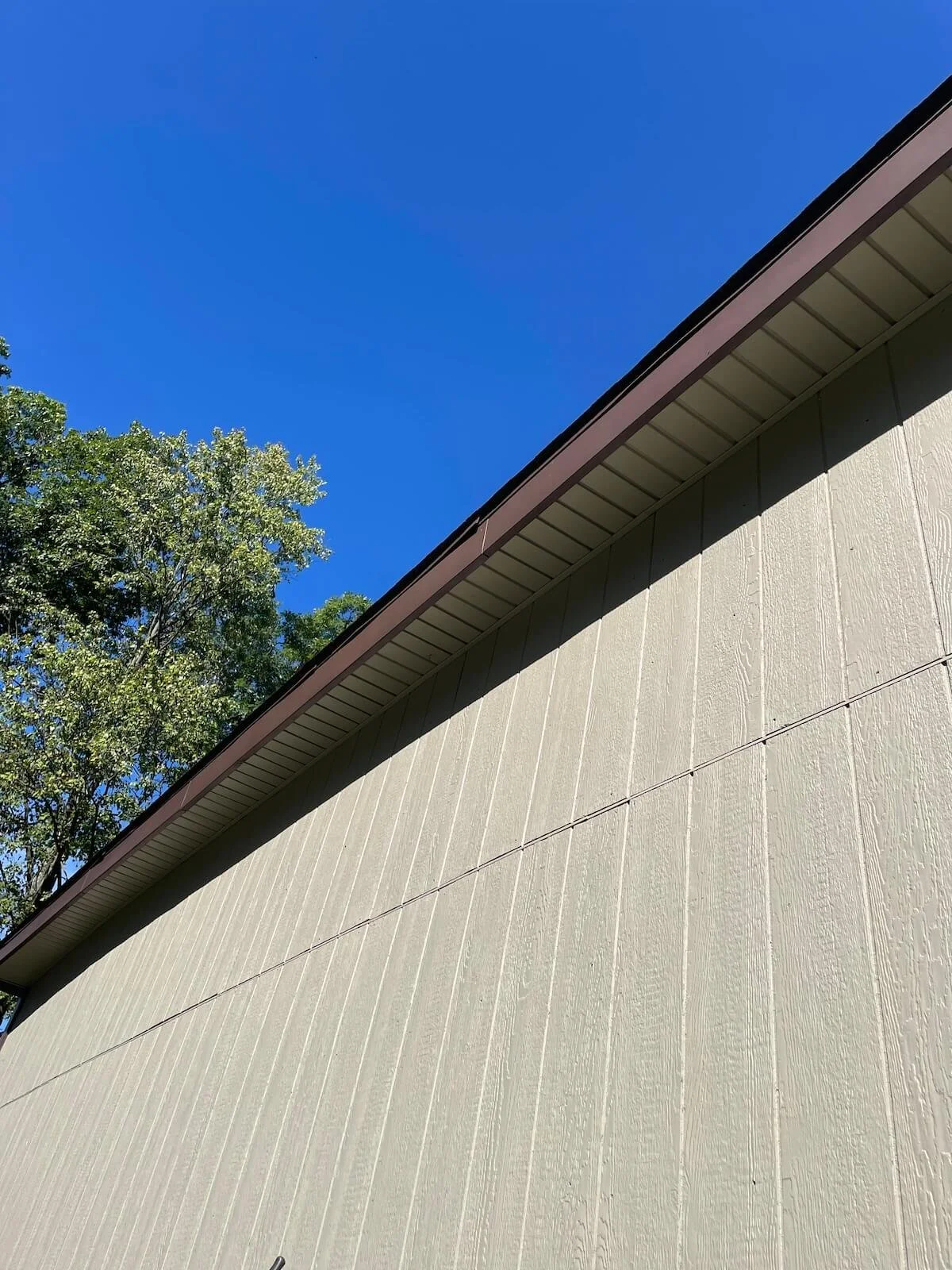 Full side profile view demonstrating seamless architectural alignment of the new 24x24 pole barn with the existing property layout.