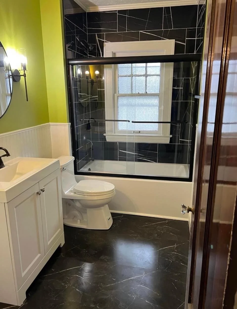 DLR Construction complete bathroom remodel in Northeast Ohio showing a new vanity custom tiling and sliding glass shower doors
