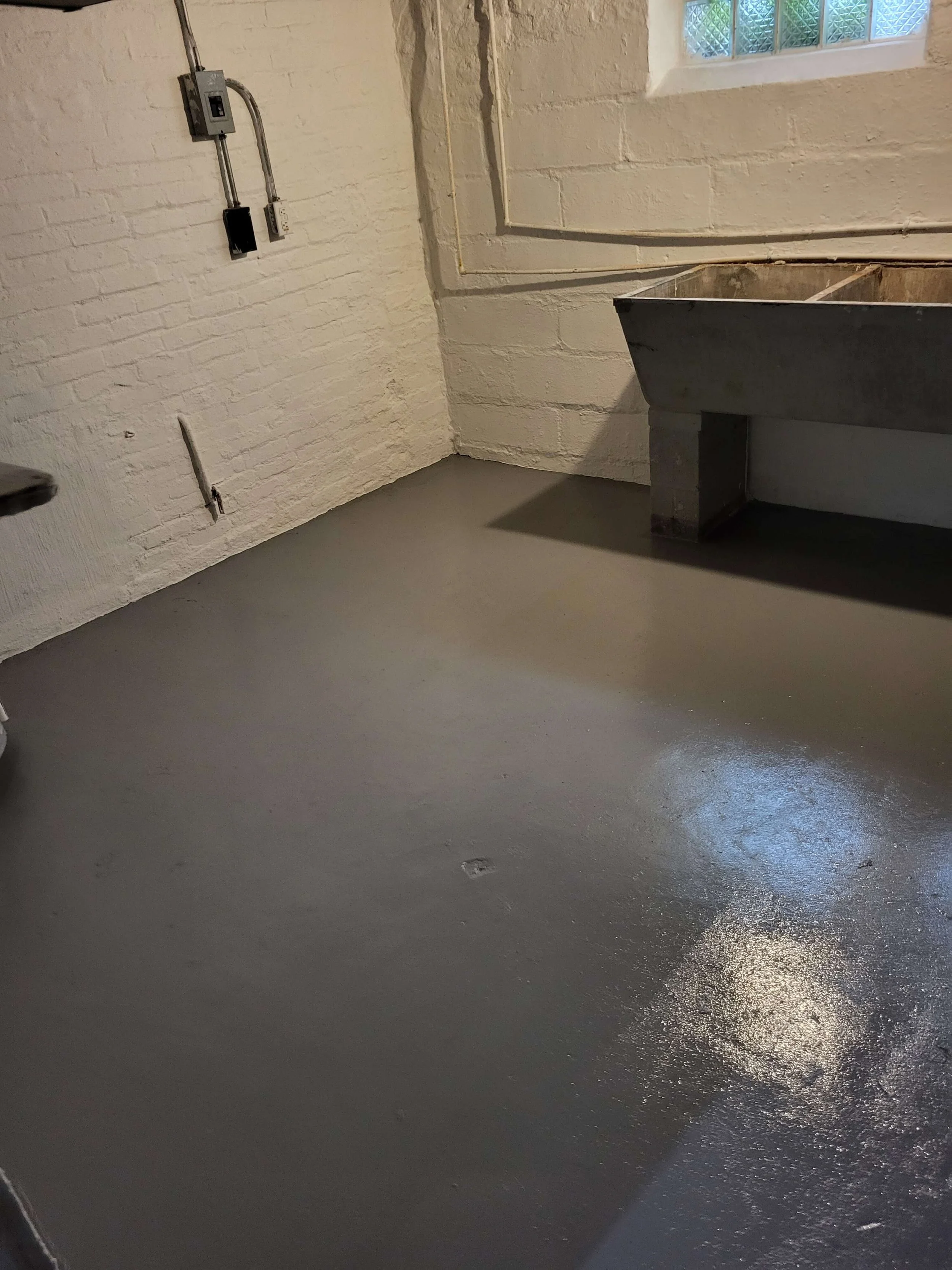Finished basement remodeling and concrete floor coating by DLR Construction in Tallmadge Ohio.