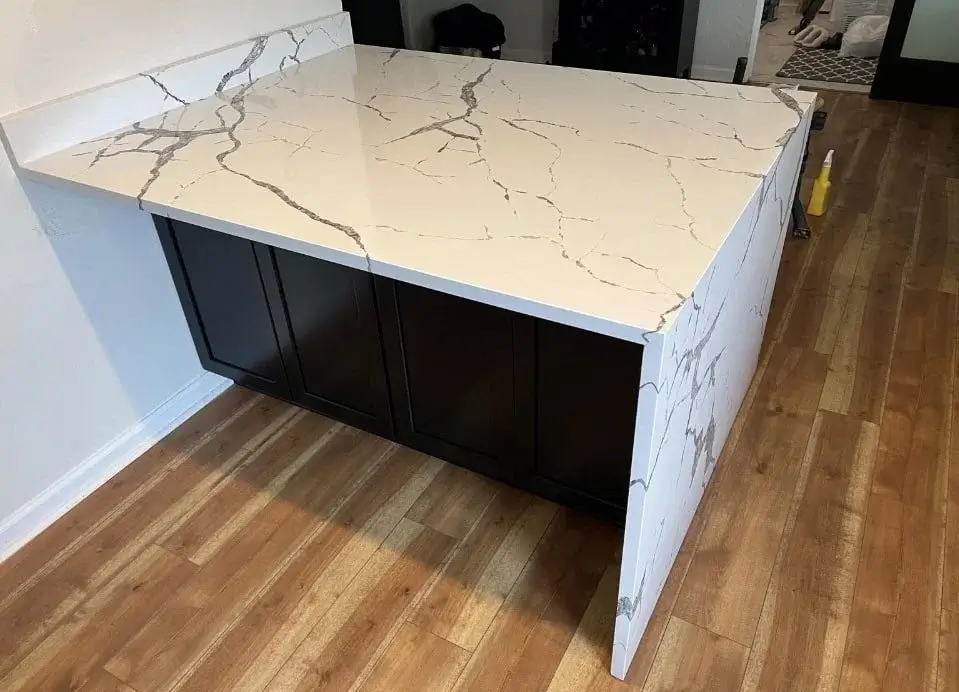 DLR Construction custom kitchen island upgrade highlighting a polished marble veined quartz waterfall countertop edge
