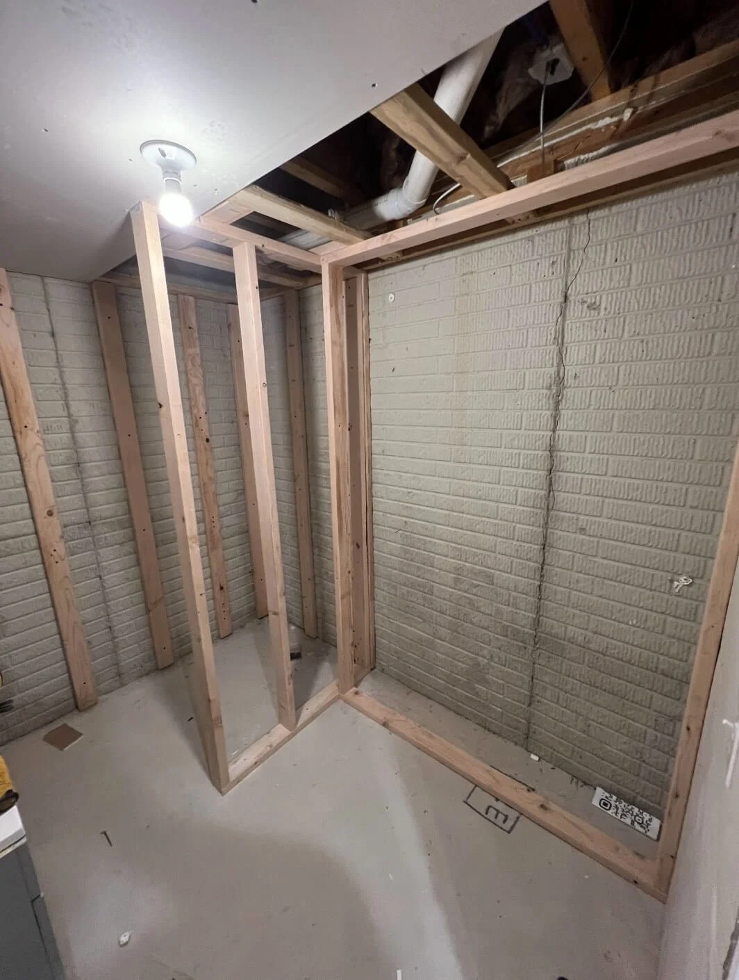 DLR Construction basement bathroom rough framing studs against concrete block walls in Canton Ohio