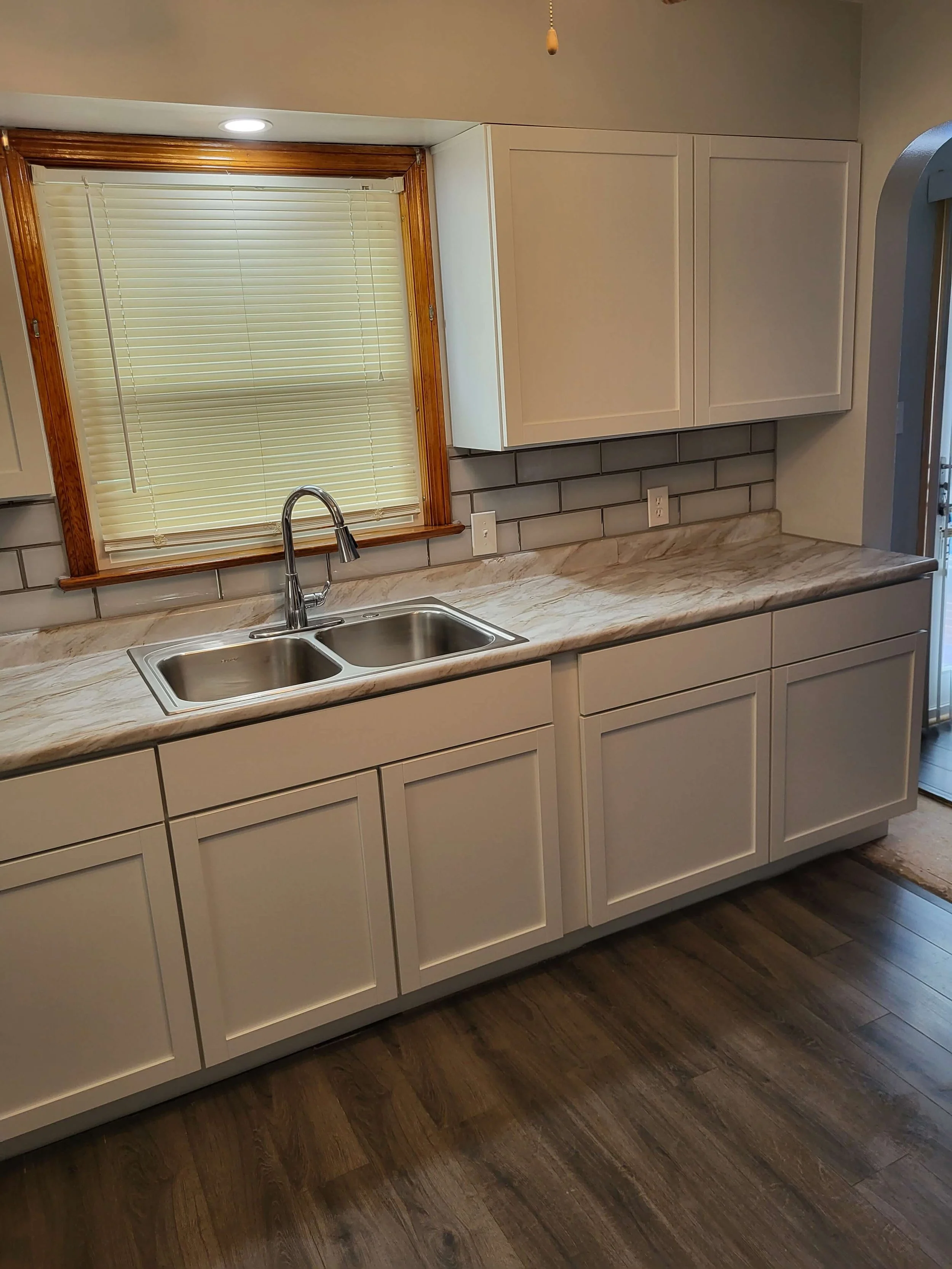 DLR Construction Cleveland kitchen renovation project featuring modern cabinets and custom white subway tile backsplash work