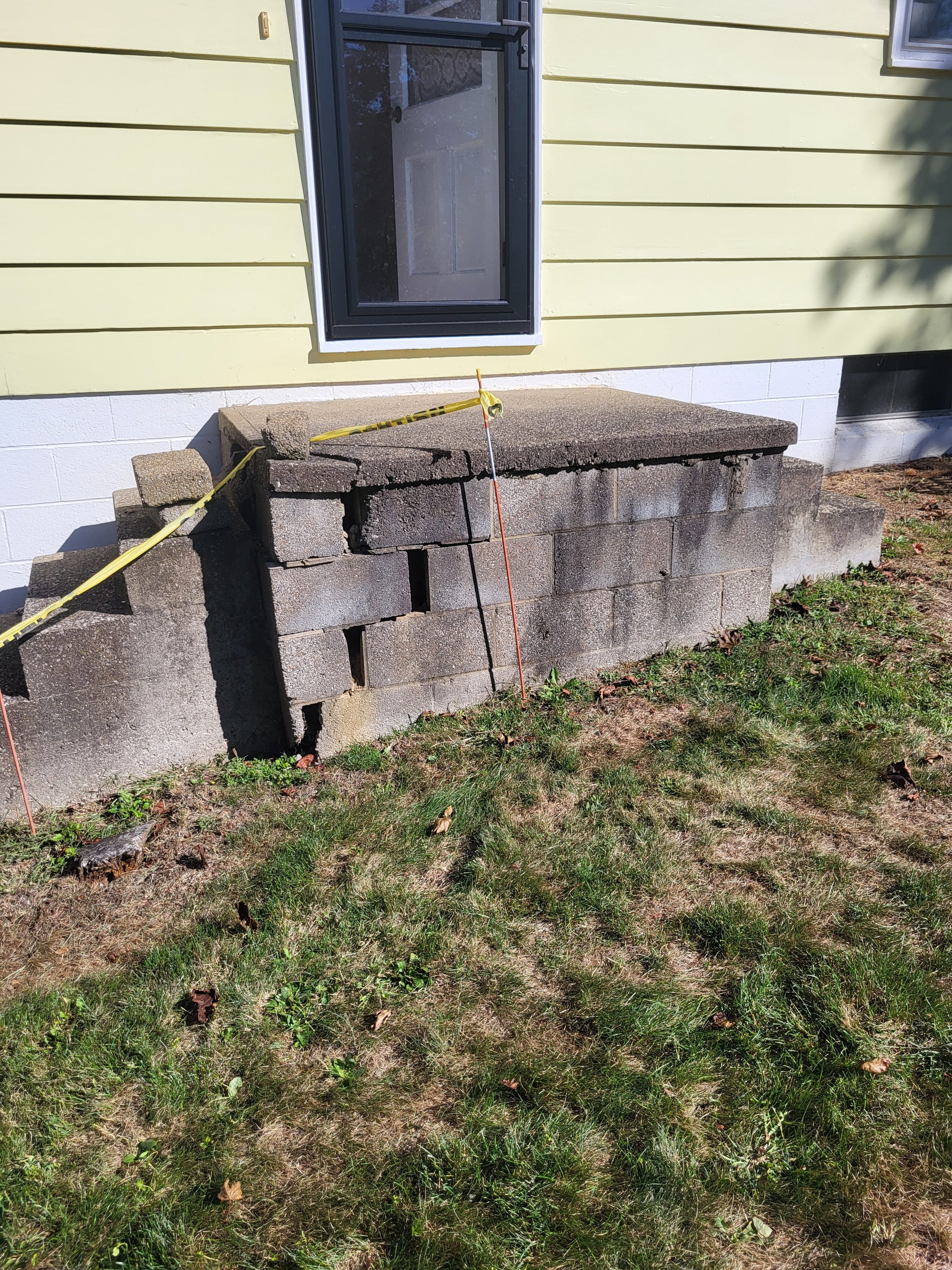 Before Exterior Renovations by DLR. Side Entrance with Cracked Foundation. Unsafe Conditions.