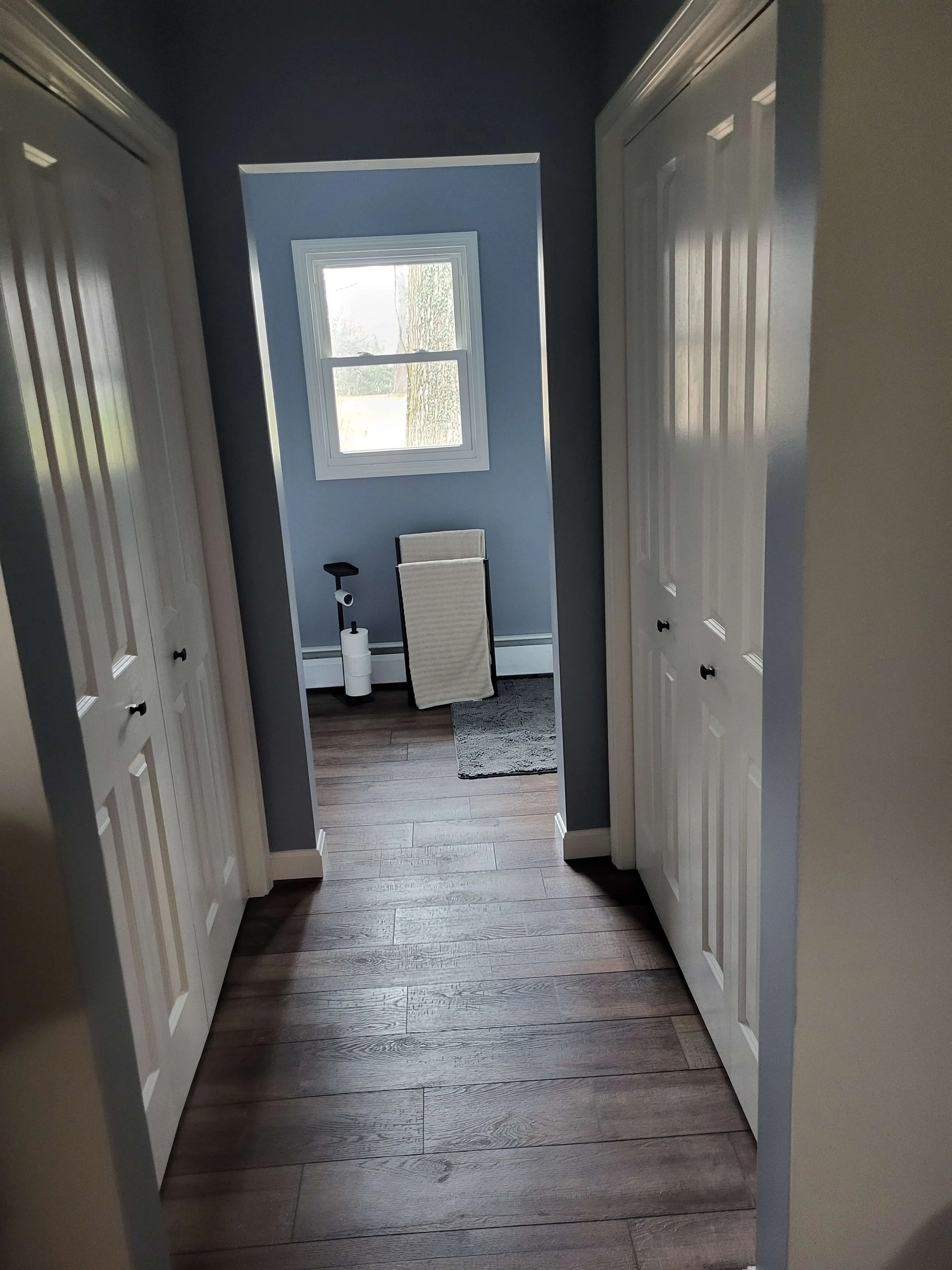 Complete bathroom renovation and seamless hallway flooring by DLR Construction in Stow Ohio