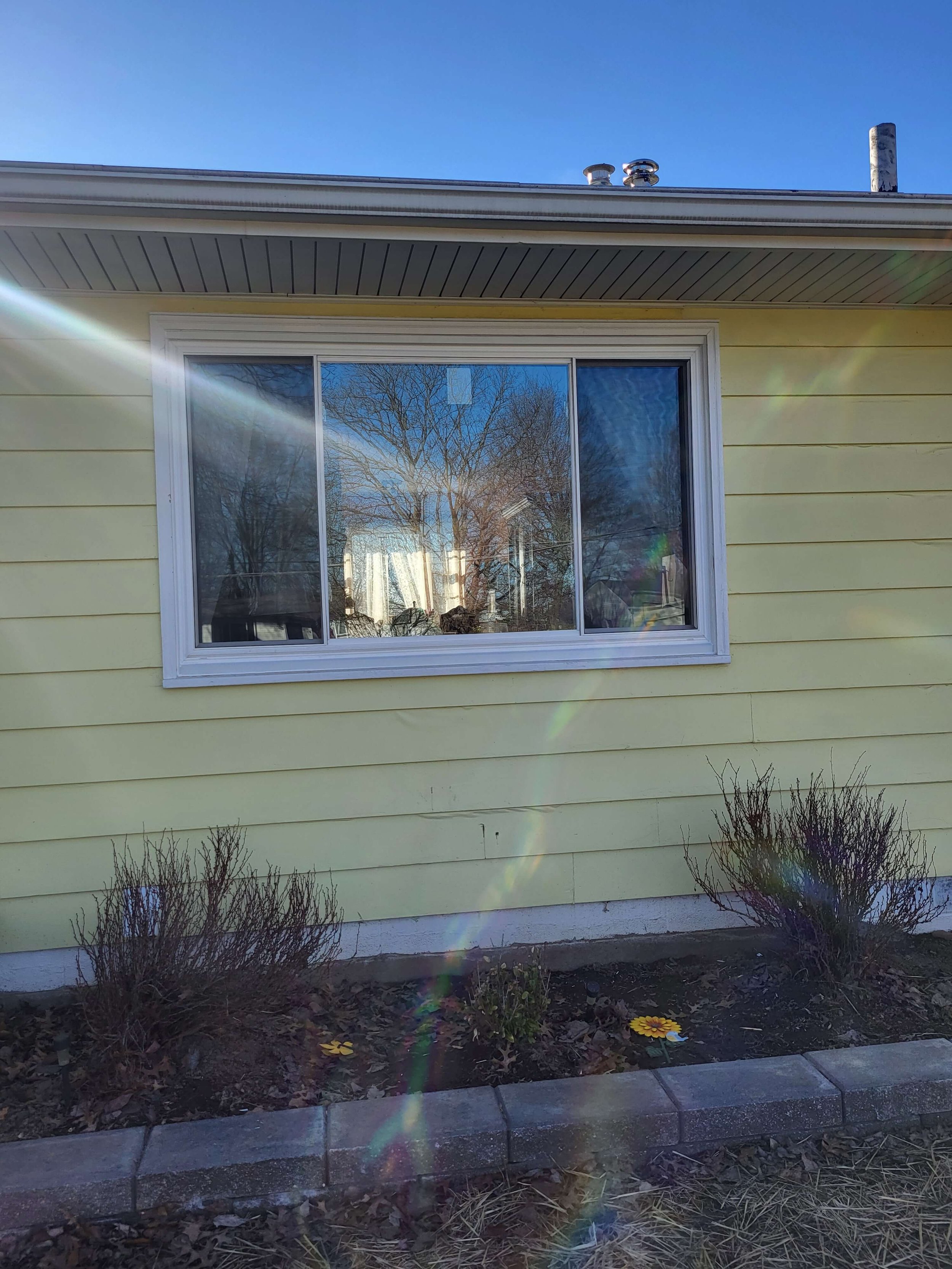 Close up of a newly replaced energy-efficient architectural bay window with custom metal wrapping in Cuyahoga Falls, Ohio by DLR Construction.
