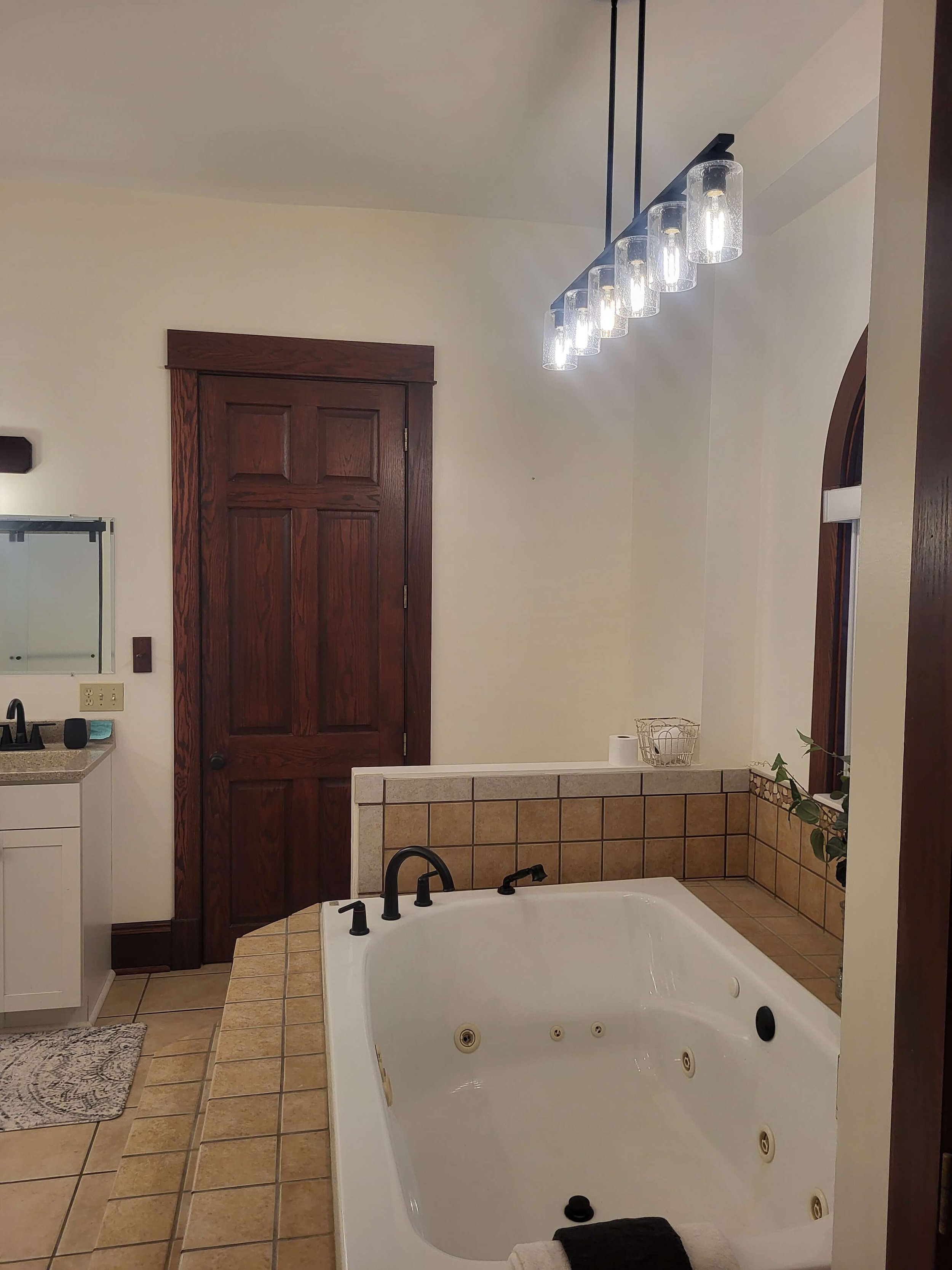 Wall Refinishing Services with custom lighting in a newly renovated bathroom