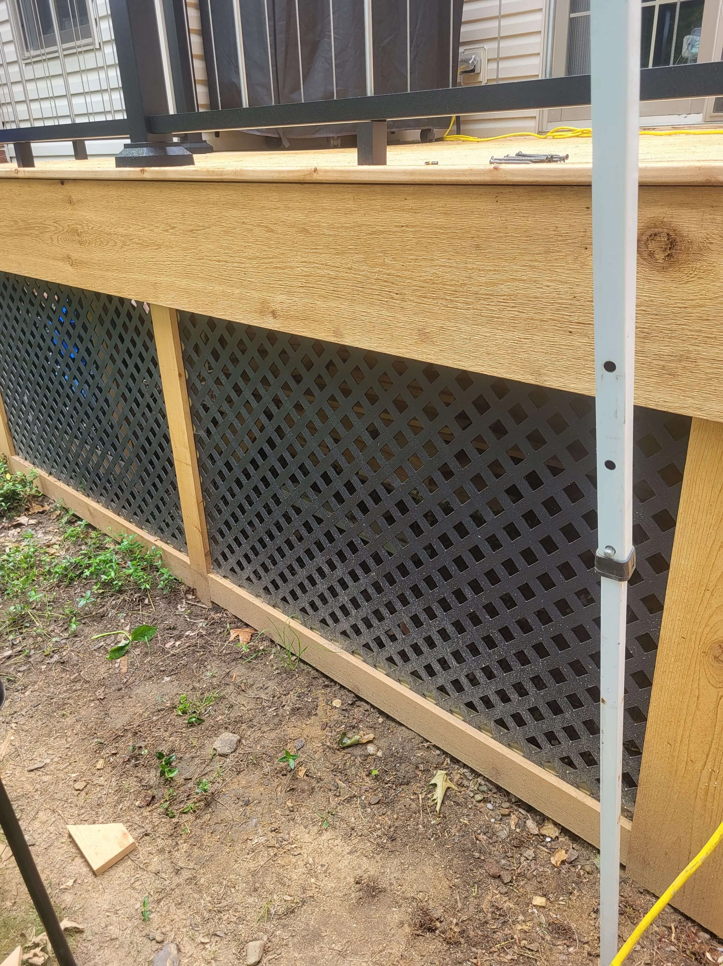 Cedar deck with black skirting and lattice detail adding contrast and a clean finished look in Northeast Ohio