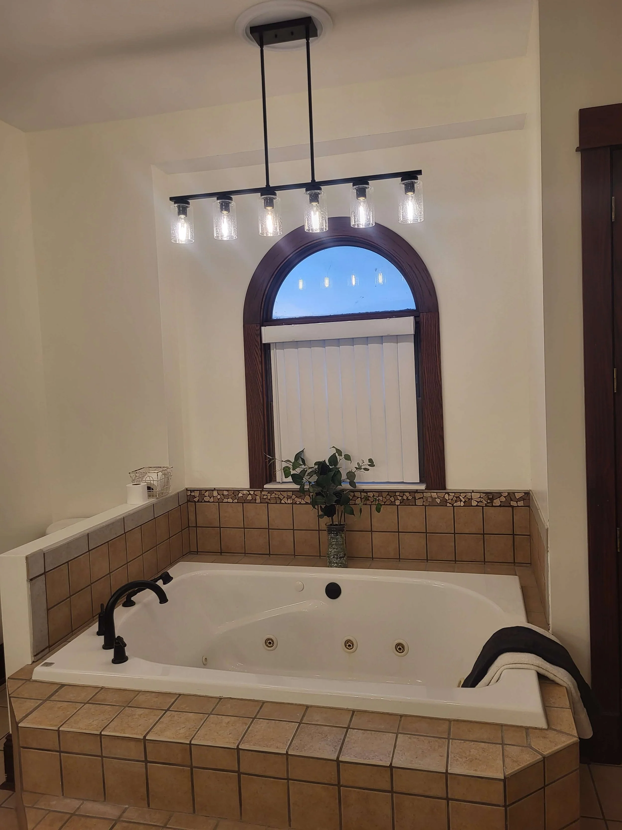 Bathroom remodel featuring arched window and natural light design