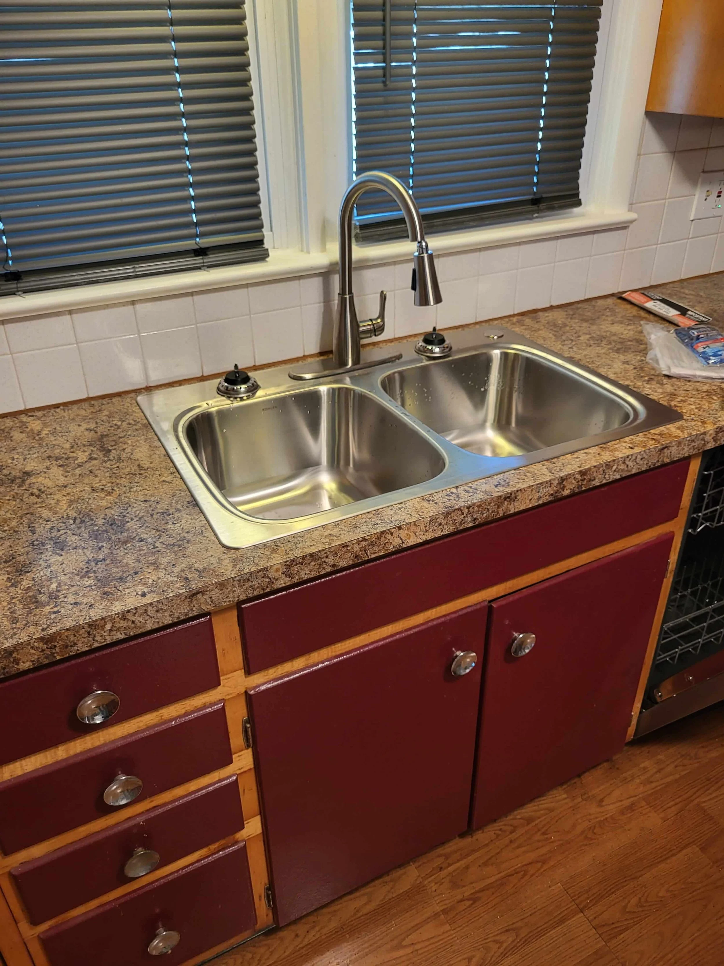 New laminate countertop installation and double basin stainless steel sink by DLR Construction in Akron Ohio.