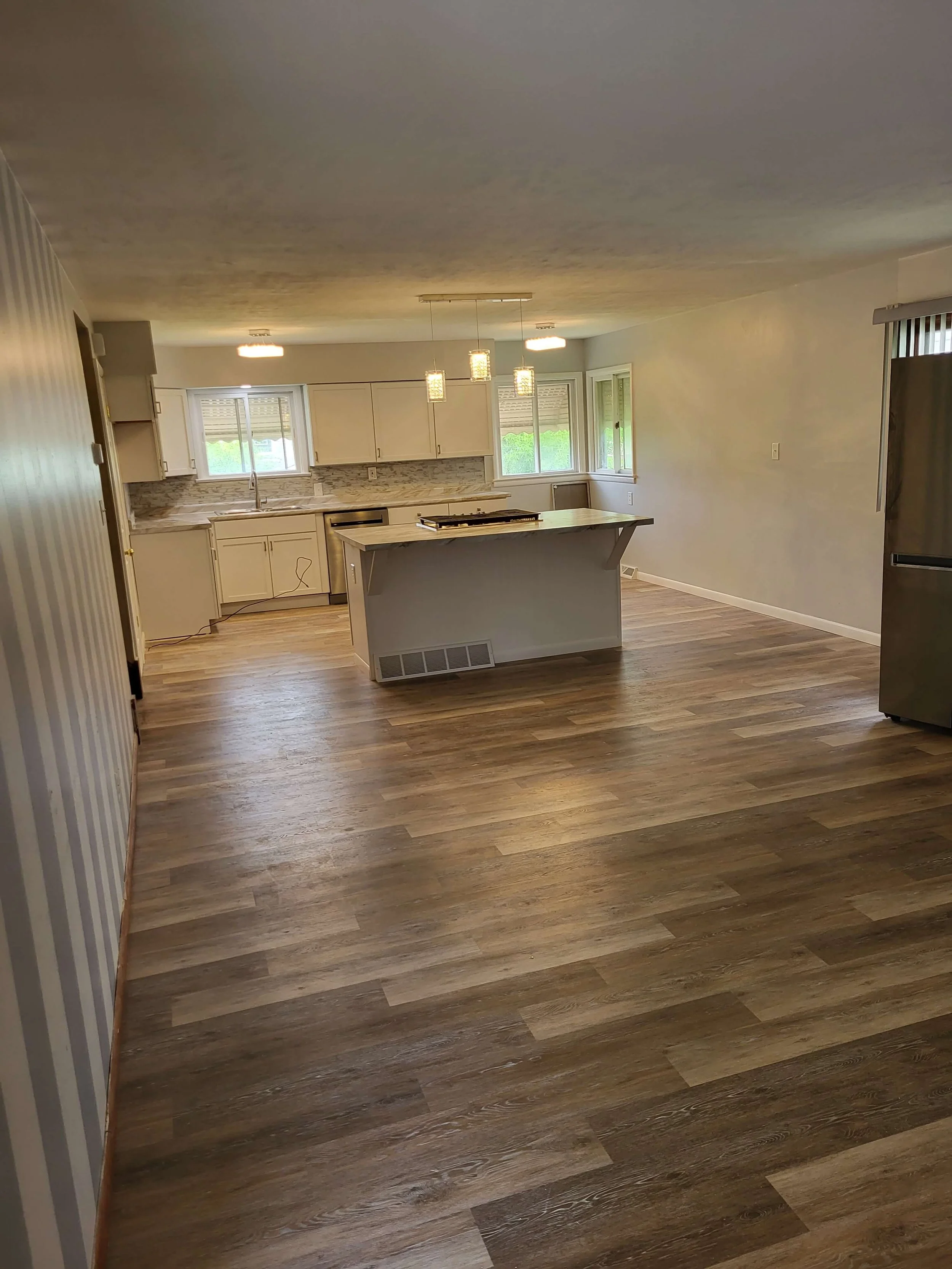 New flooring installed throughout kitchen and connected rooms during Canton Ohio remodel