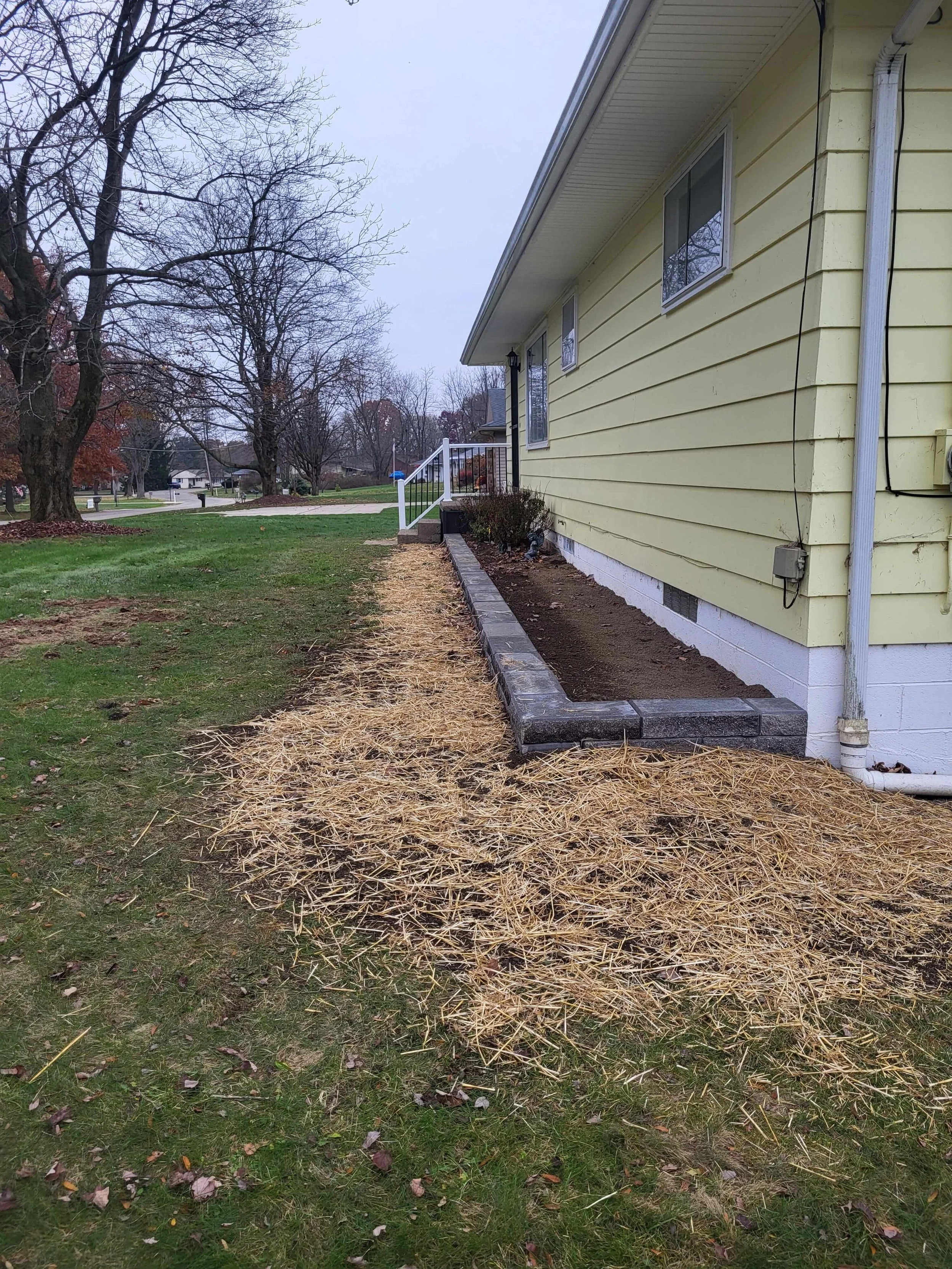 Power-washed concrete stoop with solid landscaping blocks completed by DLR Construction in Cuyahoga Falls.