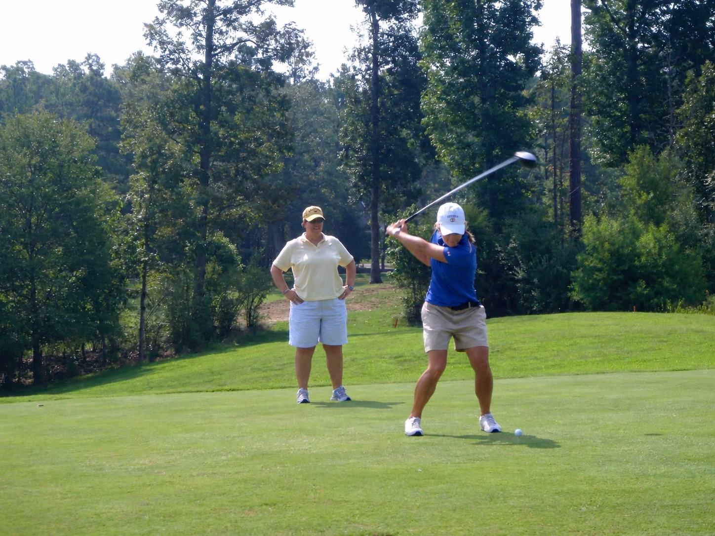 Blue Shirt Golf Swing on the Fairway.png