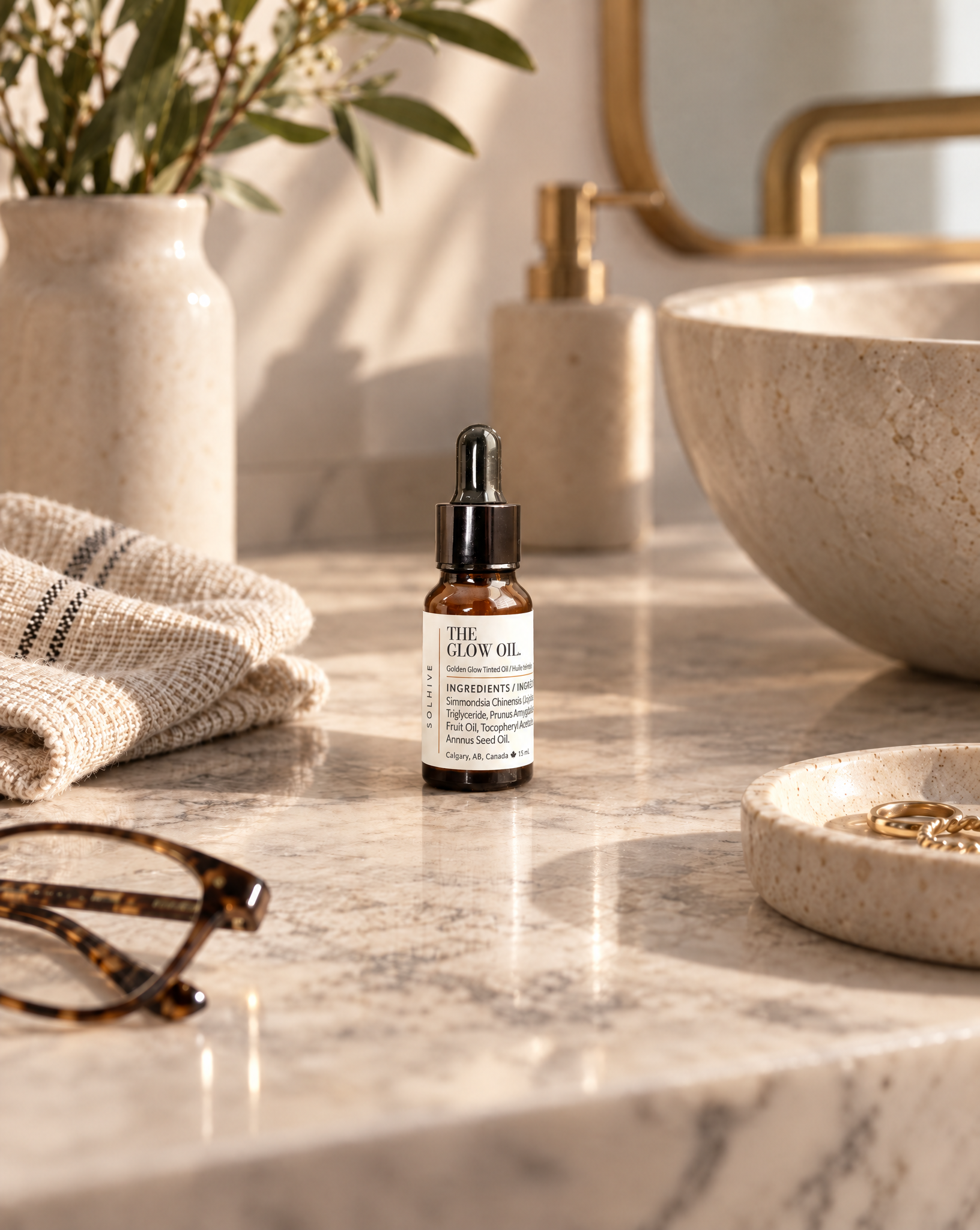 The Glow Oil on a stone vanity.png