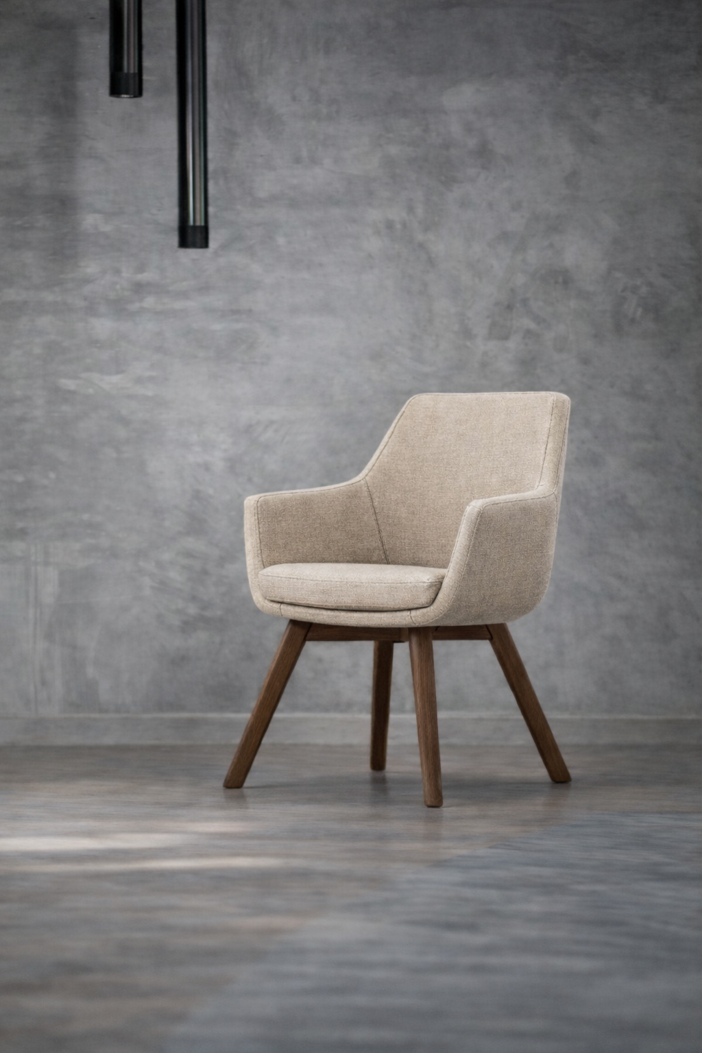 Chaise de style moderne avec tissu beige et jambes en bois, placée dans une pièce avec un mur gris et un sol en bois.