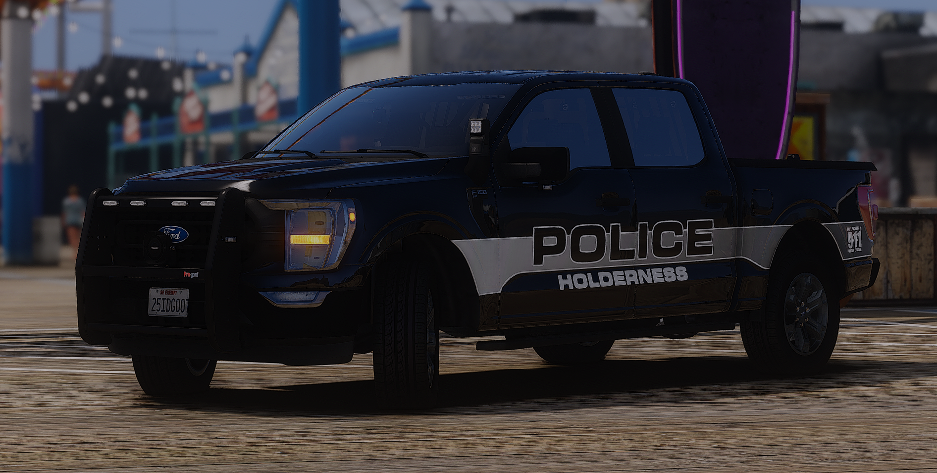 A police pickup truck with 'POLICE HOLDERNESS' markings, parked on a wooden surface.