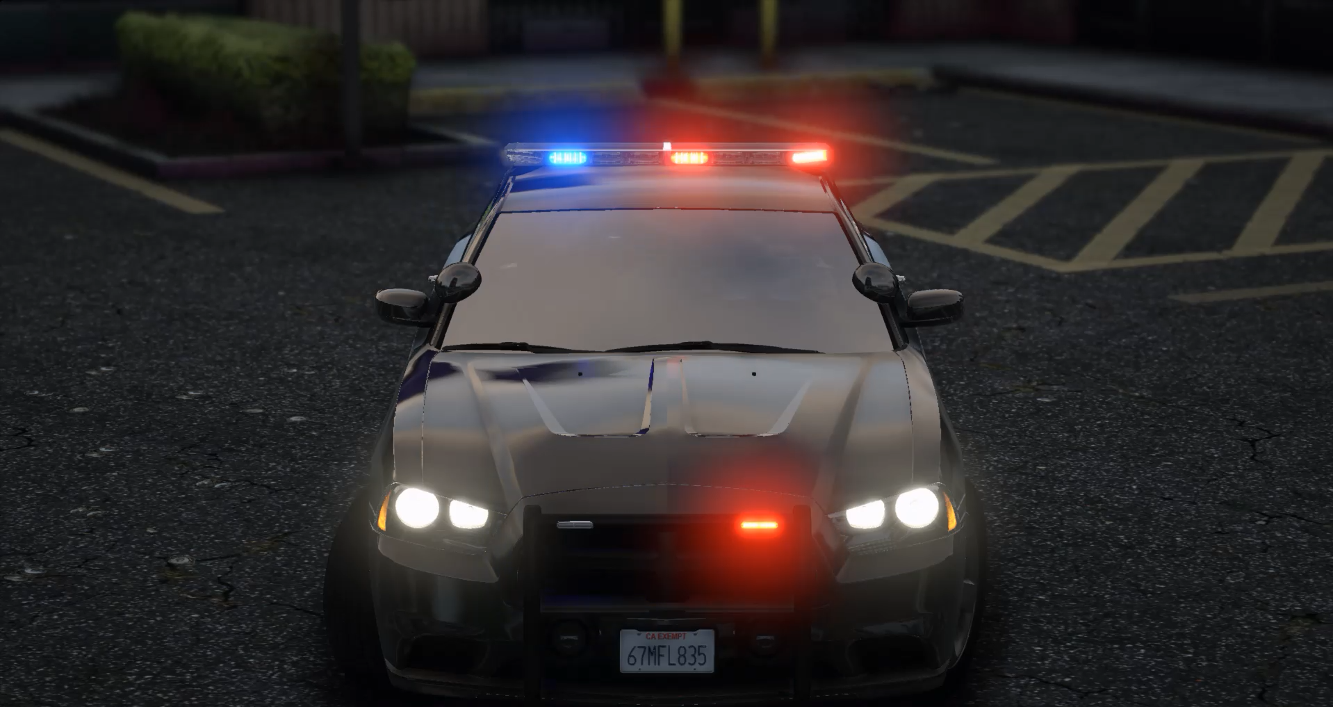 Police car with flashing blue and red lights in a parking lot at night.