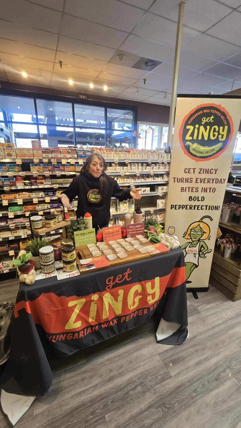 A woman at a booth promoting Hungarian wax pepper relish called Get Zingy. 
