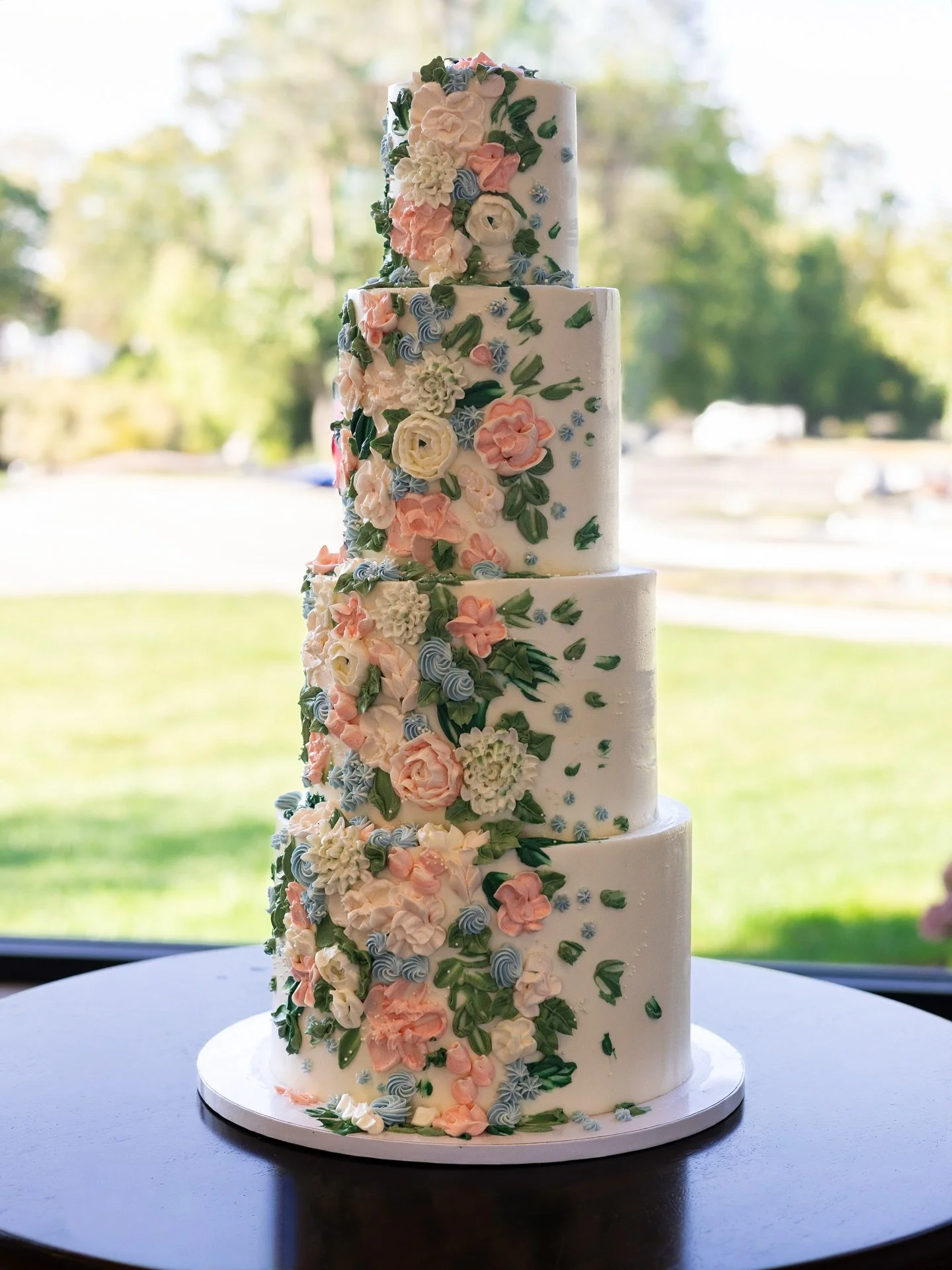 Love in painted buttercream bloom 🤍 

4 tiers of almond cake with vanilla buttercream set up at the gorgeous venue my husband and I got married in 4 years ago.

#weddingcake #floralcake #paintedbuttercream #buttercreamflowers #cakeartist #weddingcak
