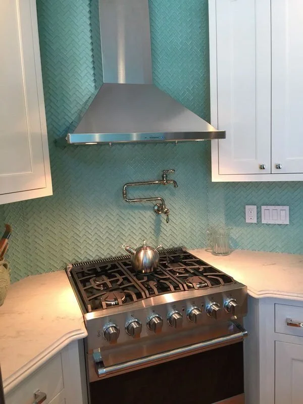 Turquoise backsplash with a herringbone pattern in a remodeled kitchen in Mashpee by At Design Remodel.jpg
