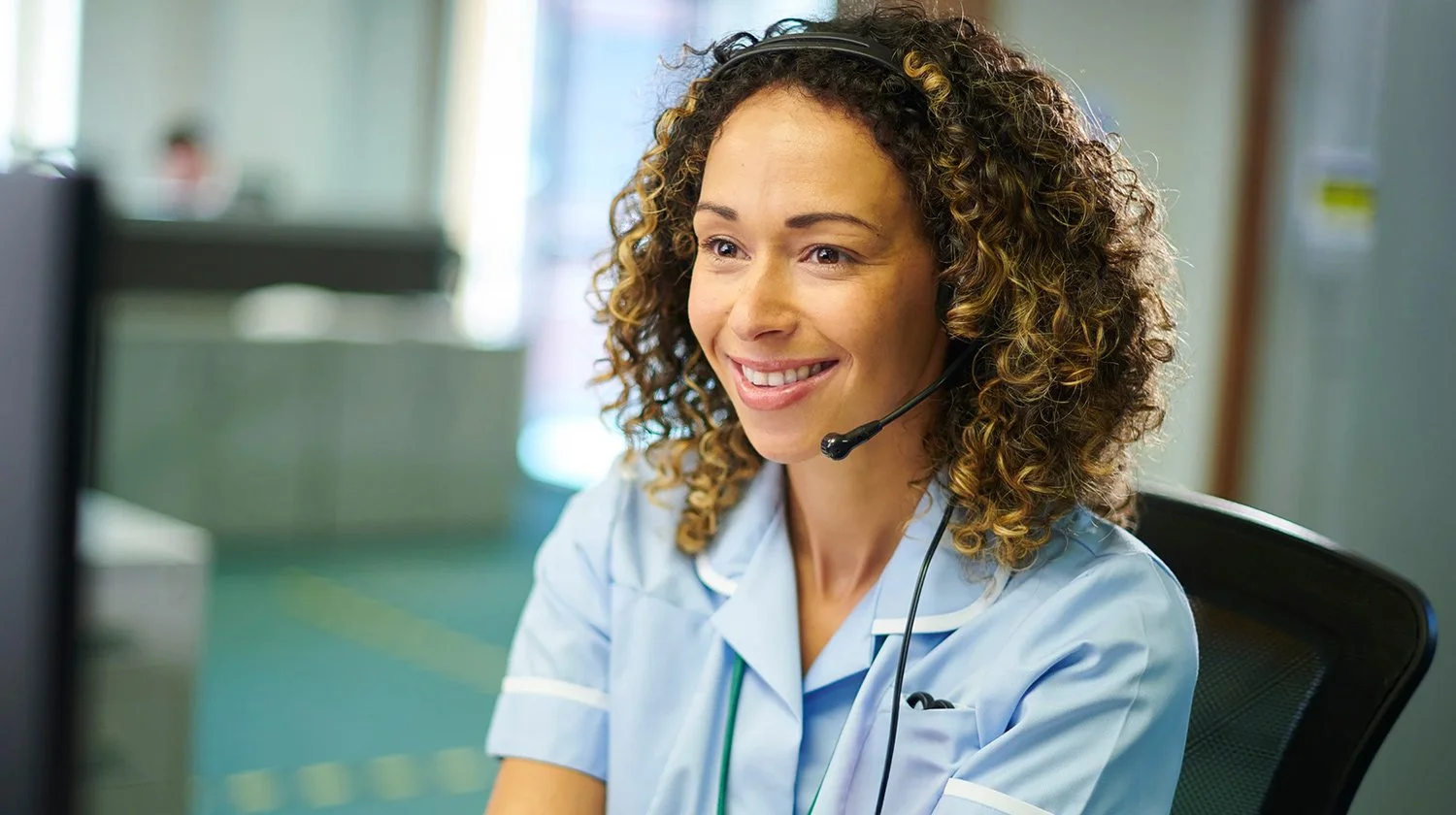 Friendly mental health medical billing support specialist working on insurance claims at a computer with Forward Revenue Management