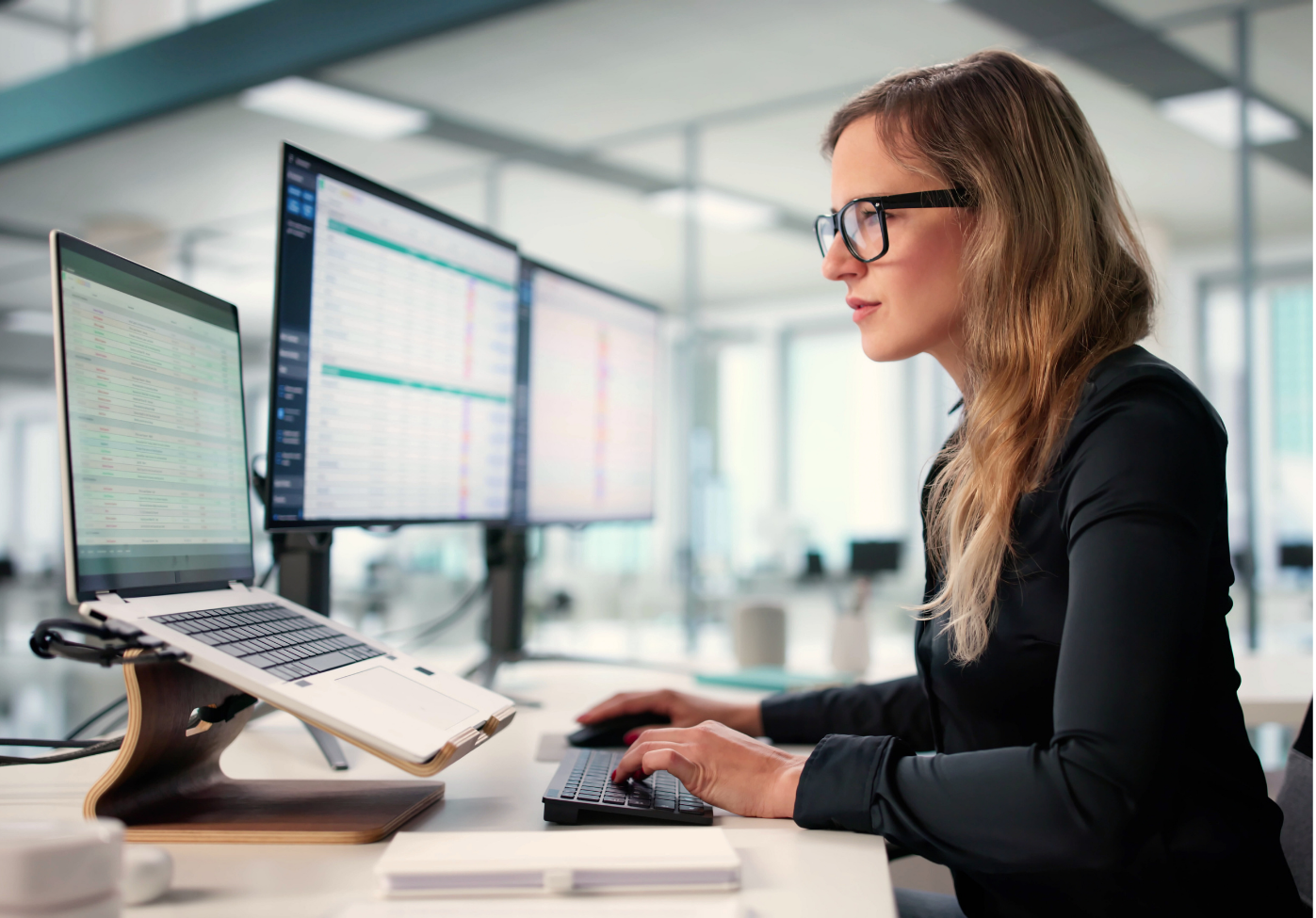 Businesswoman working at her desk nationwide medical billing and practice management support staff with Forward Revenue Management