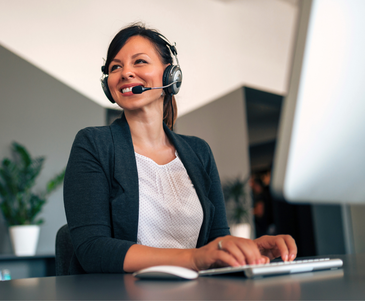 A woman wearing a headset is working on mental health medical billing support specialist working on claims with Forward Revenue Management