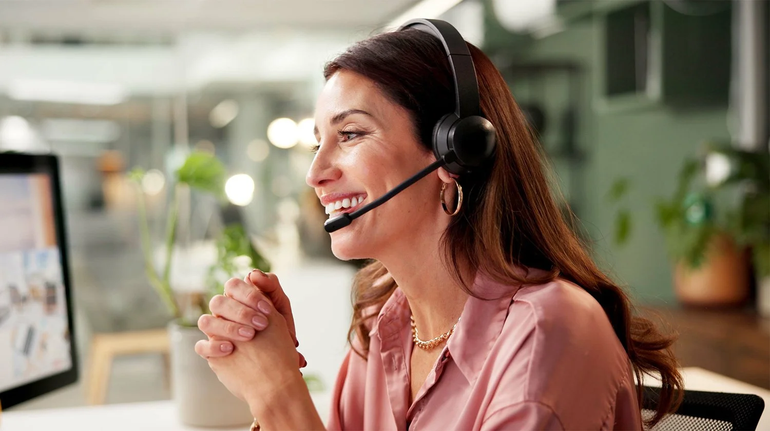 A woman working at a computer nationwide medical billing and practice management support staff with Forward Revenue Management