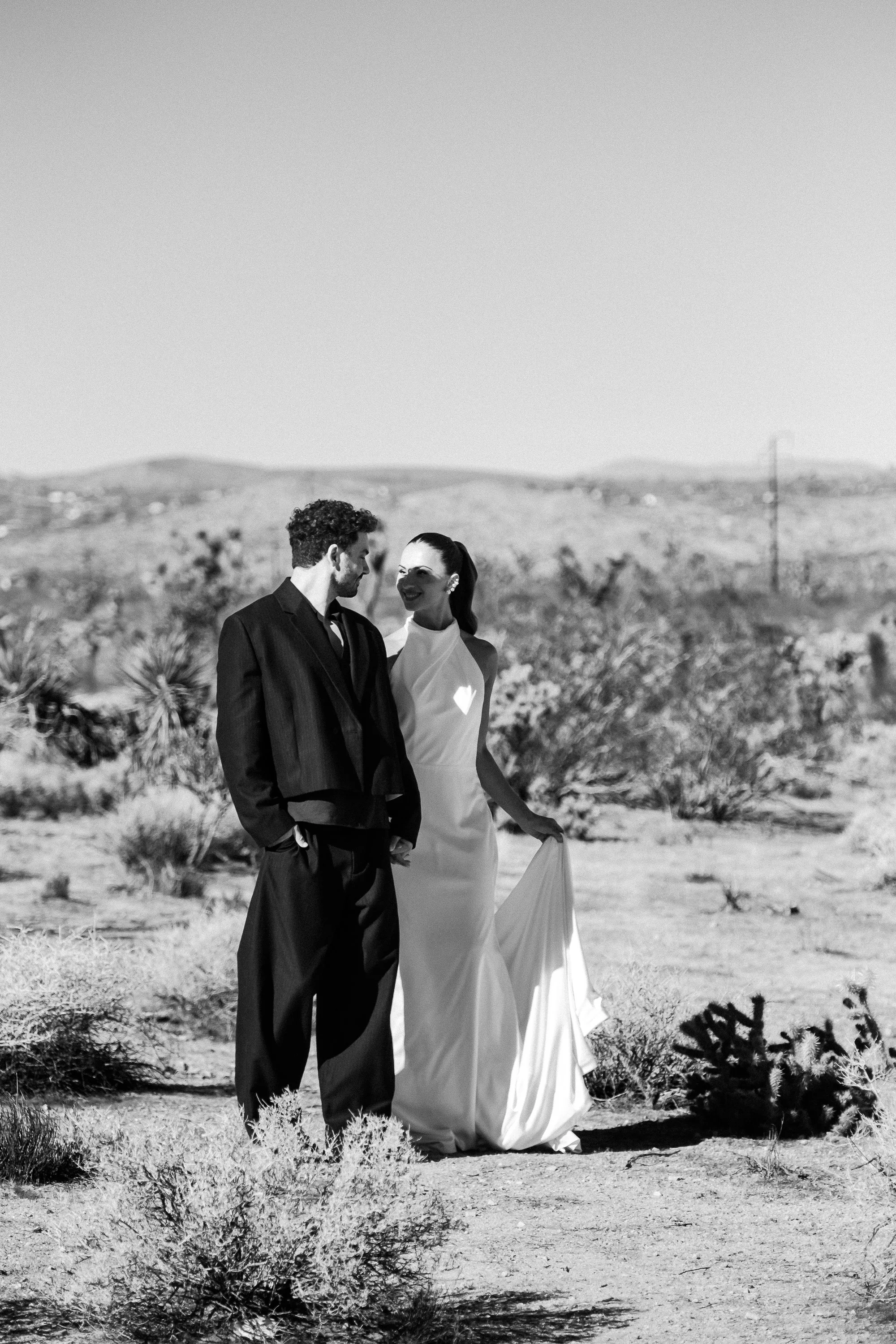Editorial portrait of the couple framed by desert landscape and natural light during a Joshua Tree wedding styled shoot.