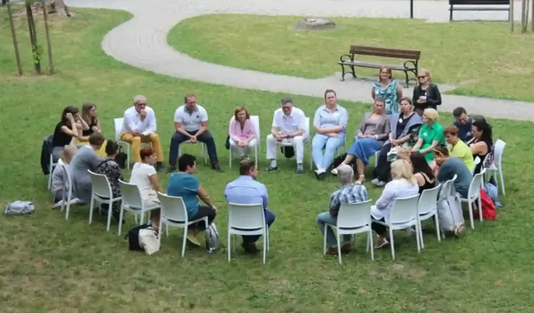 Community garden members meeting in a circle.