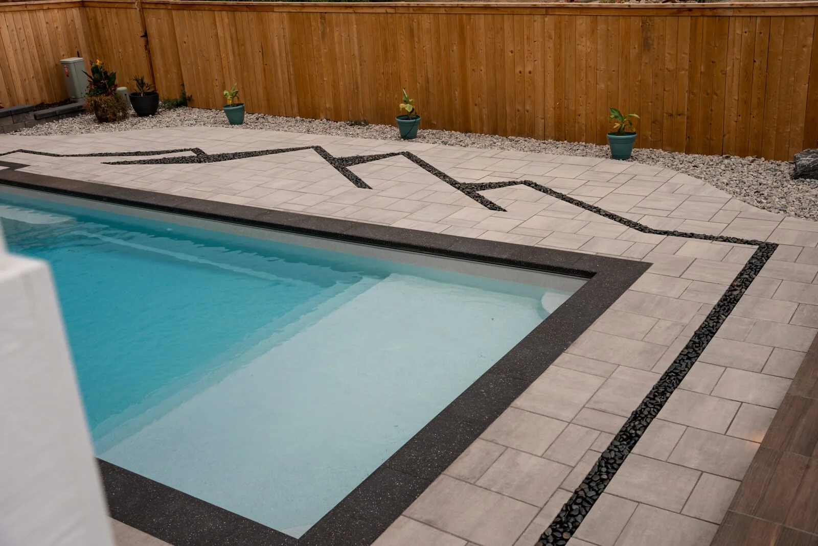 Fiberglass pool with patio paver pool deck