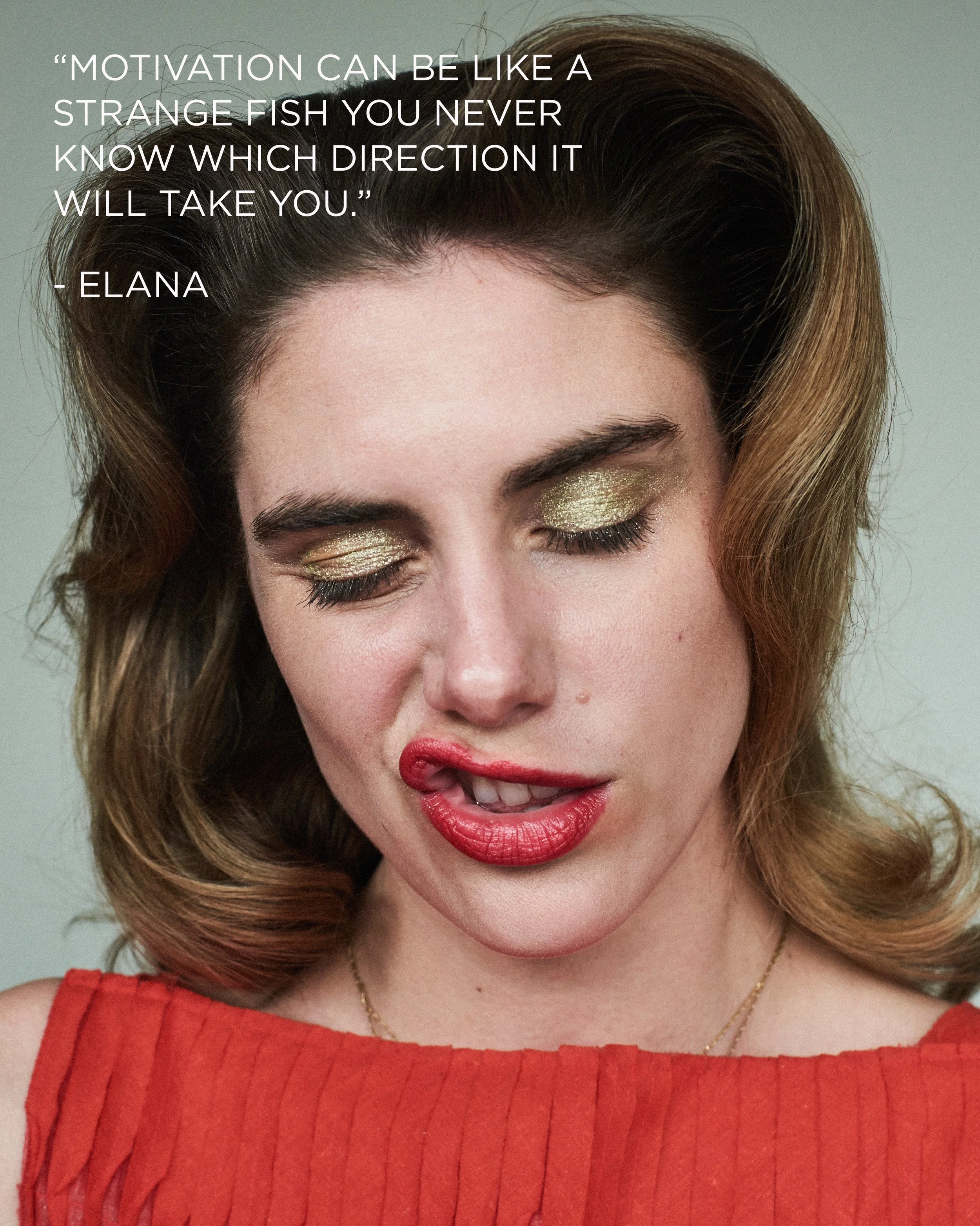 A woman with worked gold eye makeup and red lipstick, wearing a red top, with her eyes closed and her tongue slightly out, touching her lip. There is a quote on the upper left corner that reads, "Motivation can be like a strange fish you never know w