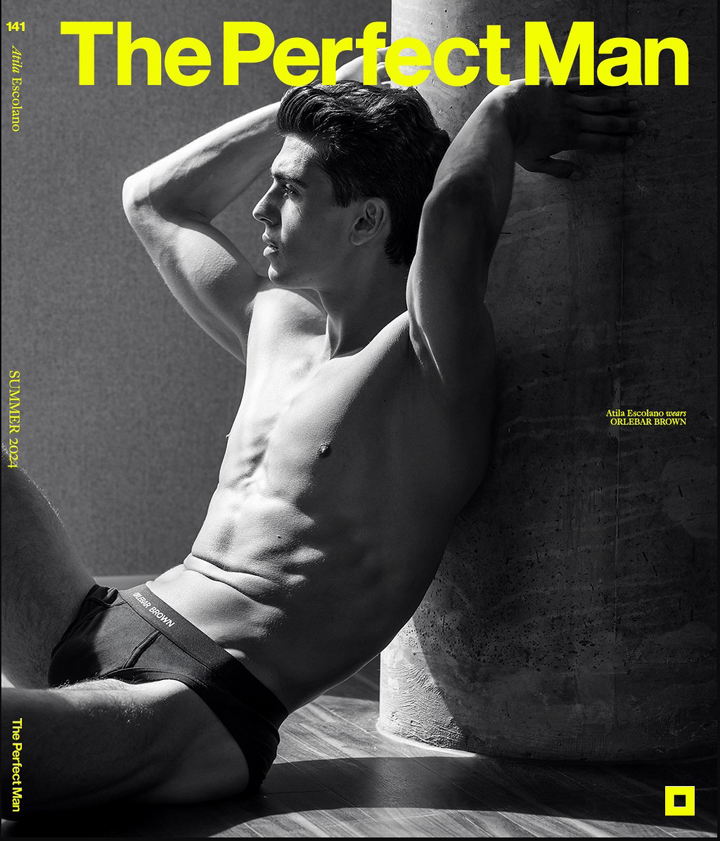Black and white magazine cover titled "The Perfect Man" featuring a shirtless male model with dark hair, sitting against a wall with his hands behind his head, wearing Orlebar Brown swimwear. The cover mentions the summer of 2024 issue and credits At