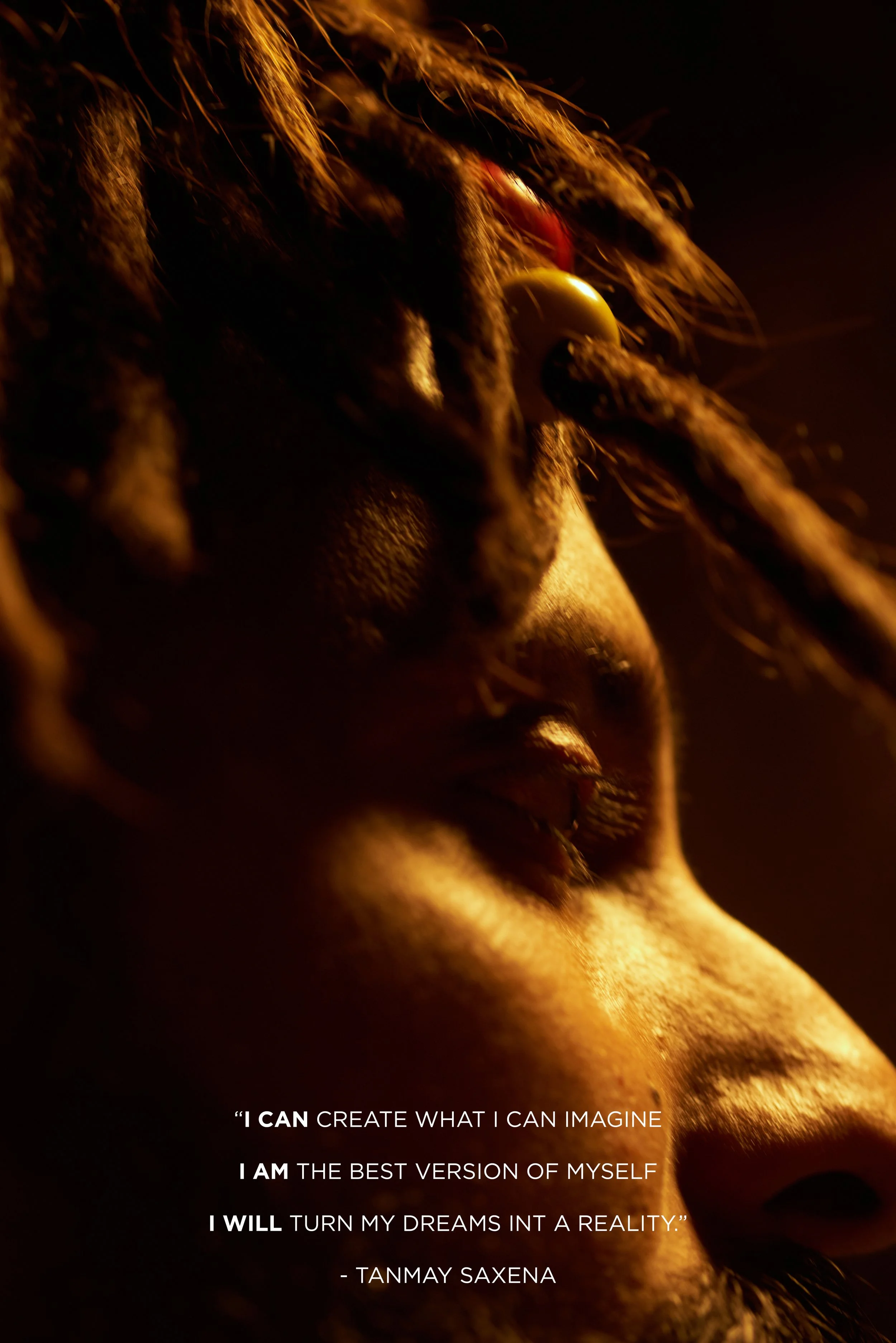 Close-up side profile of a person's face, illuminated with warm lighting, highlighting their eye, nose, and lips, with textured hair and a motivational quote overlaid.