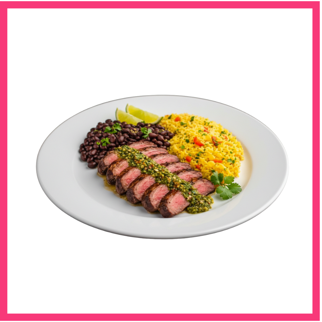 A white plate with sliced oicahna steak topped with green sauce, black beans, yellow rice with vegetables, and lemon wedges, garnished with cilantro.
