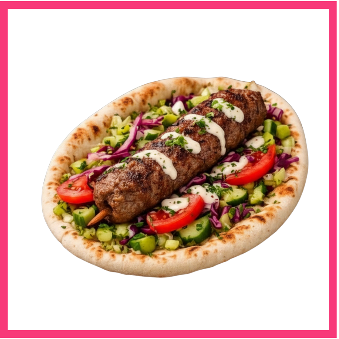 Kafta kebab on flatbread, topped with white sauce, served on a bed of chopped vegetables including tomatoes, cucumbers, and purple cabbage, with a pink background.