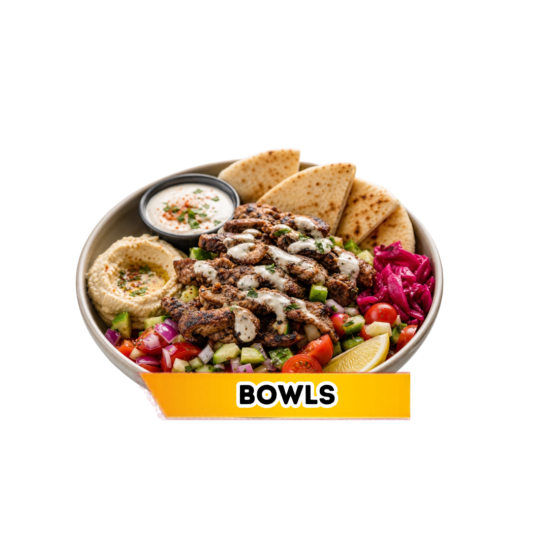 A bowl filled with grilled meat strips topped with white sauce, fresh chopped vegetables including cherry tomatoes, cucumbers, red onions, and lettuce. It also contains pita bread, a lemon wedge, green olives, a side of hummus, and a small container of creamy dressing. The bowl is labeled "BOWLS."